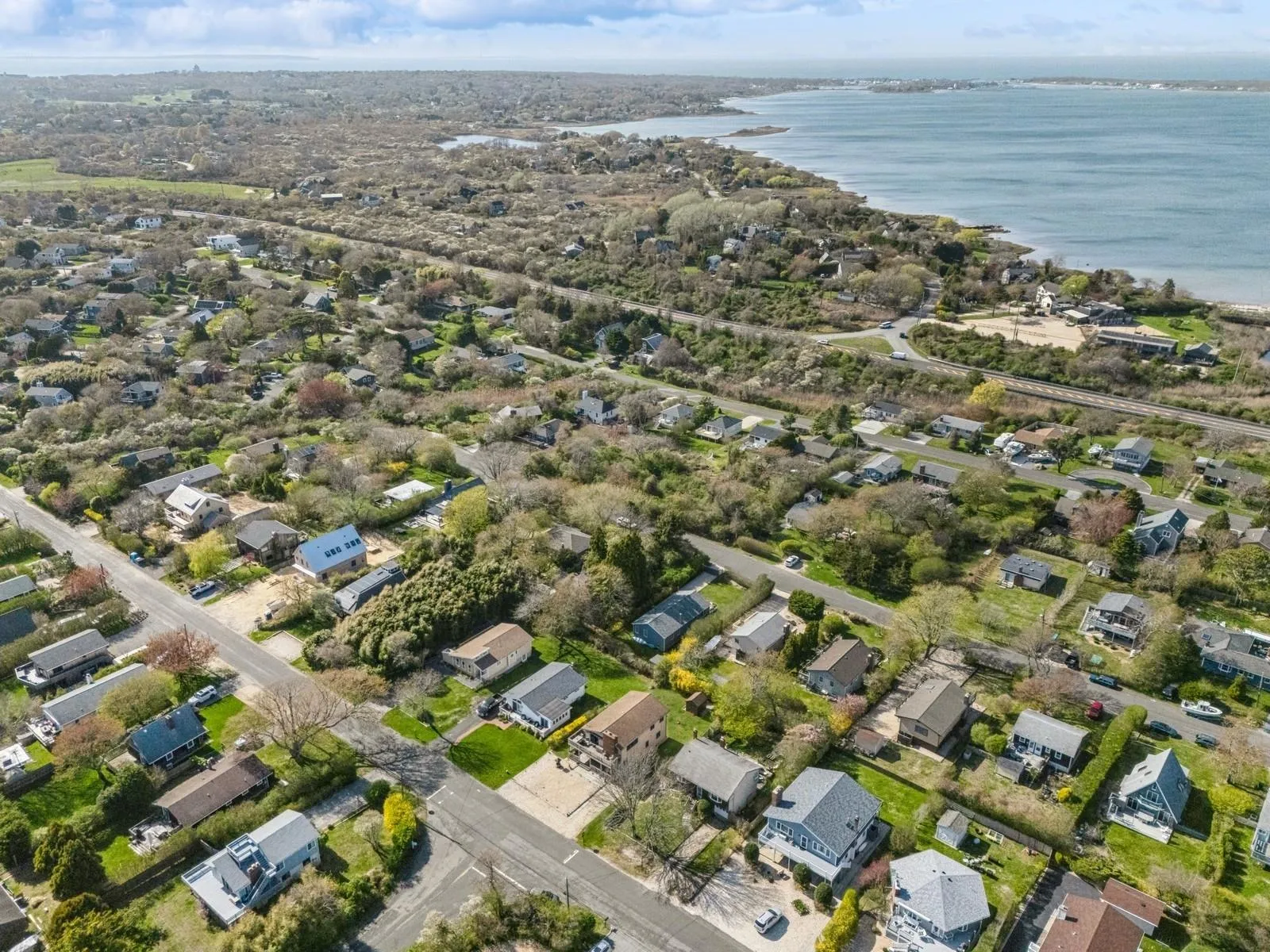 Birds eye view of property featuring a water view and a residential view Birds eye view of property featuring a water view and a residential view