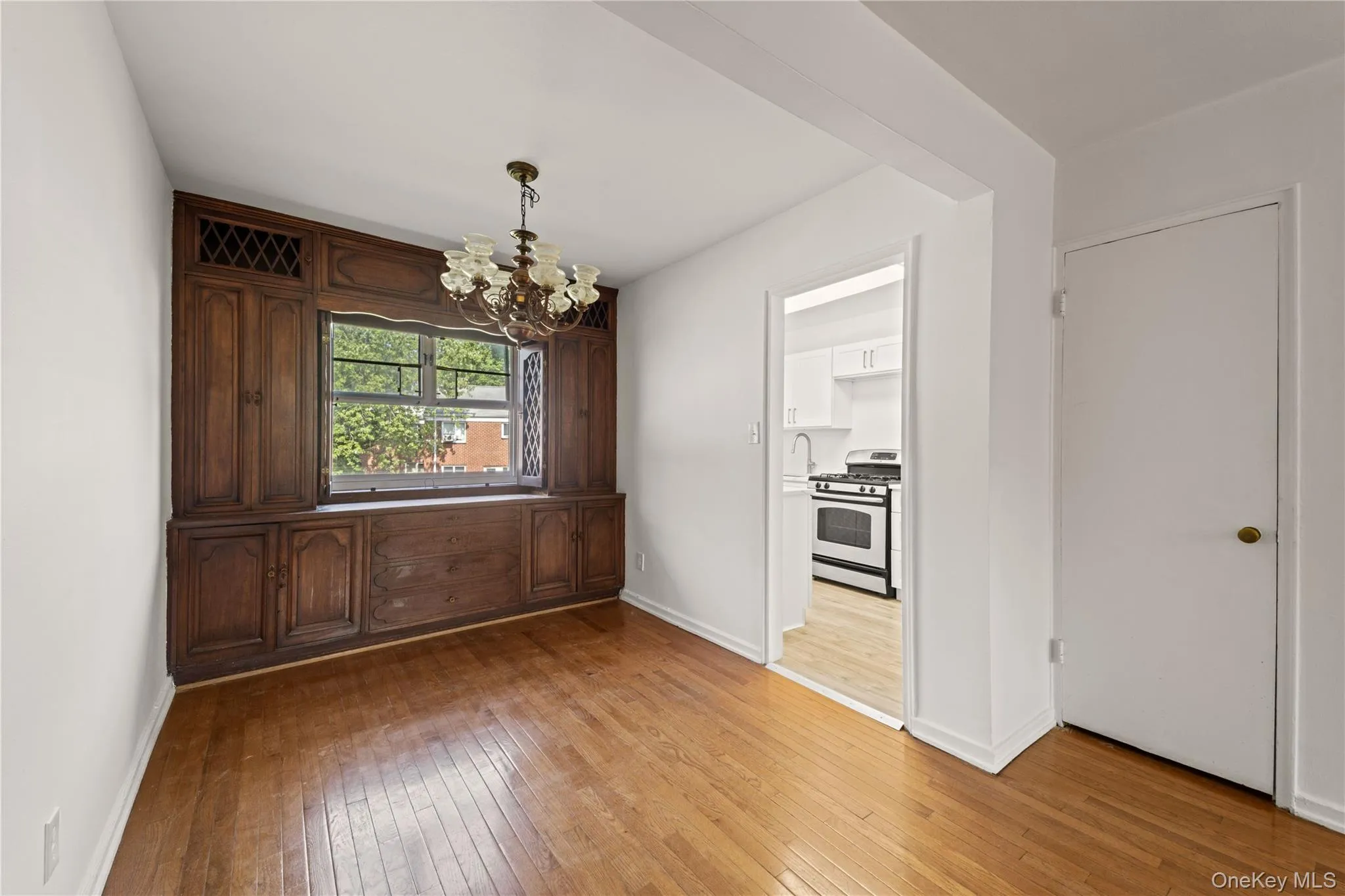 Unfurnished dining area with light wood-style floors and a chandelier Unfurnished dining area with light wood-style floors and a chandelier