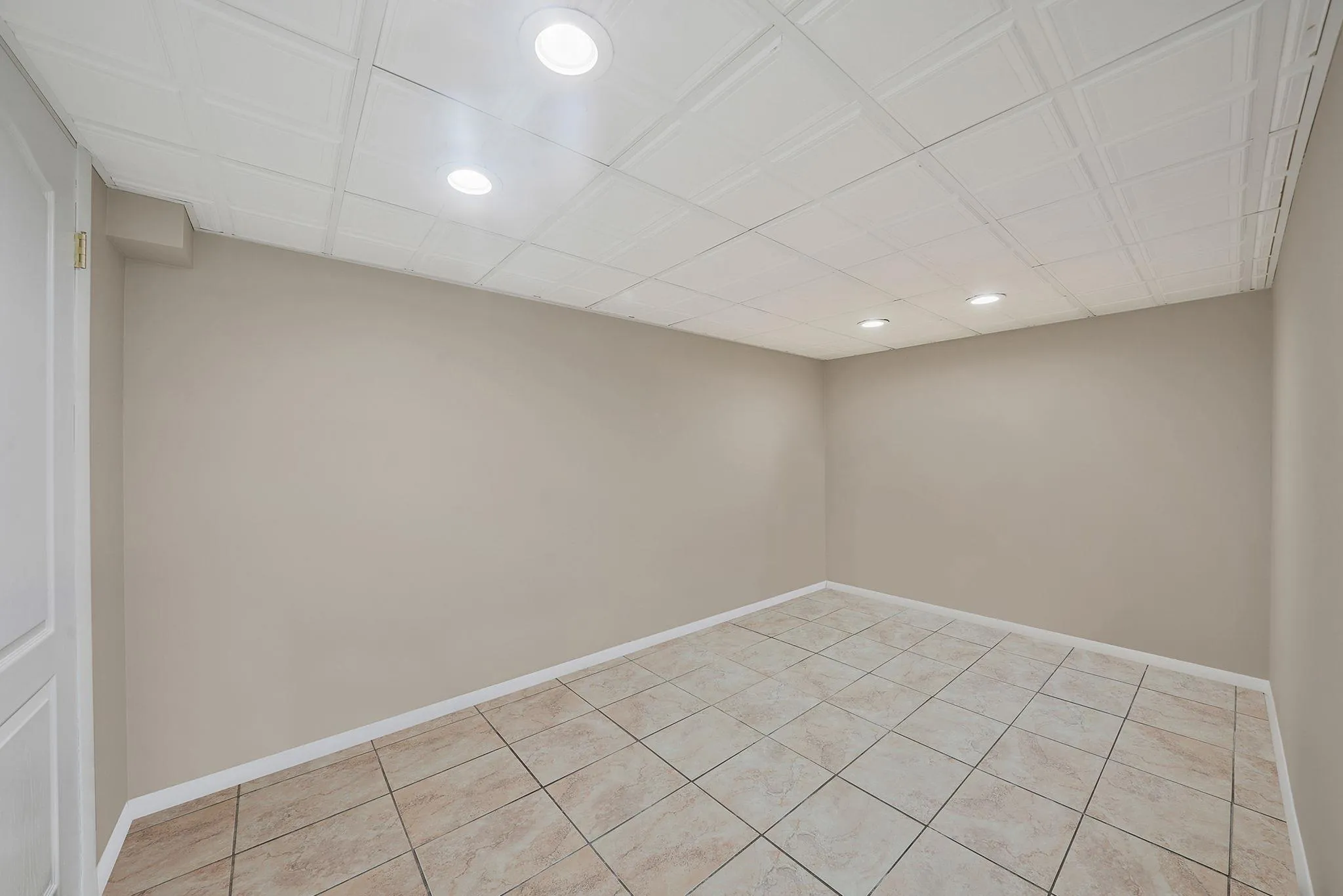 Spare room with recessed lighting, baseboards, and light tile patterned flooring Spare room with recessed lighting, baseboards, and light tile patterned flooring