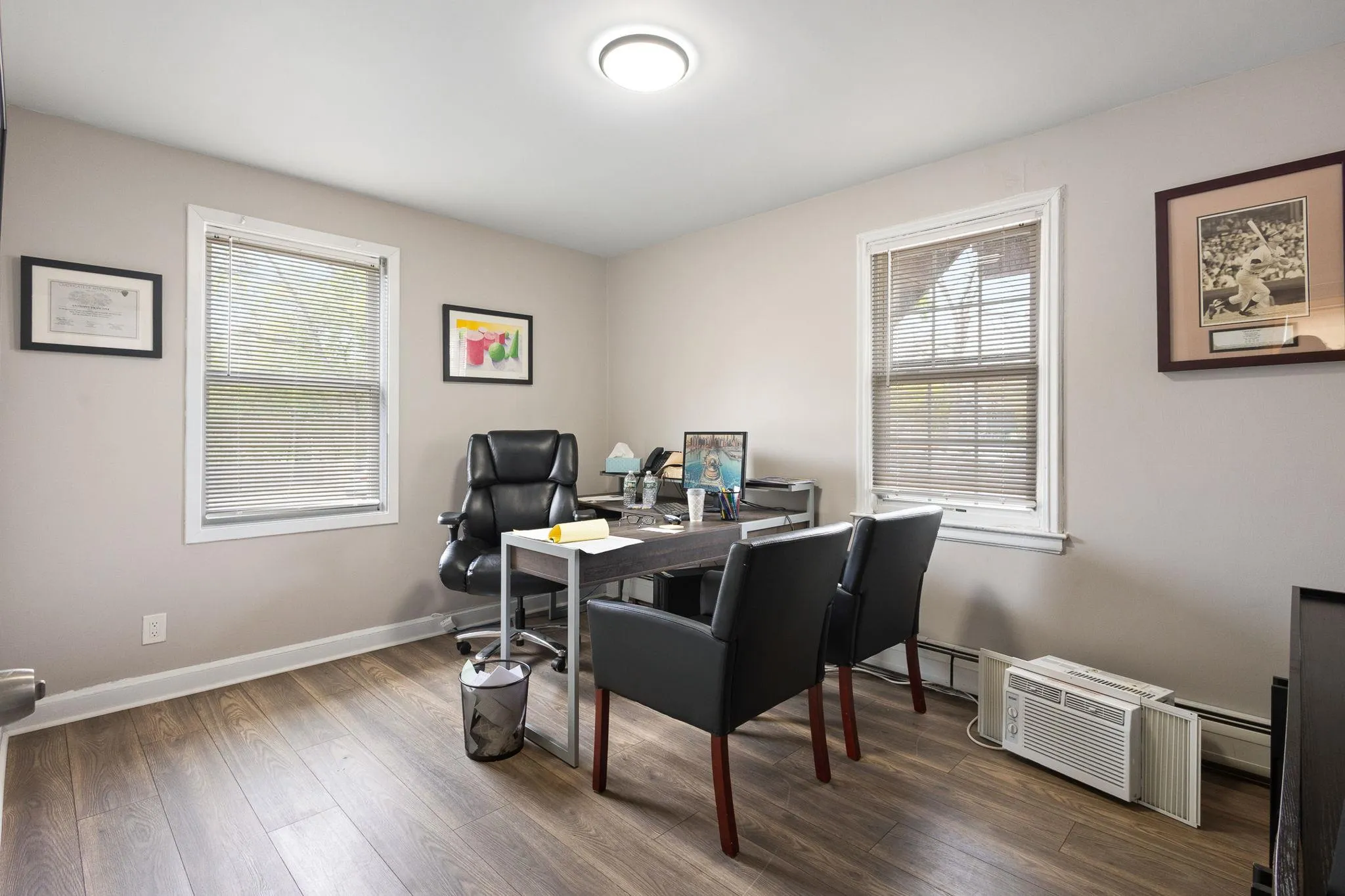 Home office featuring baseboards and dark wood-type flooring Home office featuring baseboards and dark wood-type flooring