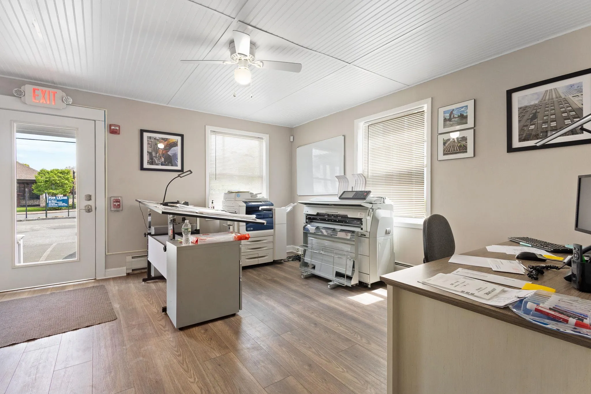 Office area with ceiling fan, baseboard heating, and wood finished floors Office area with ceiling fan, baseboard heating, and wood finished floors
