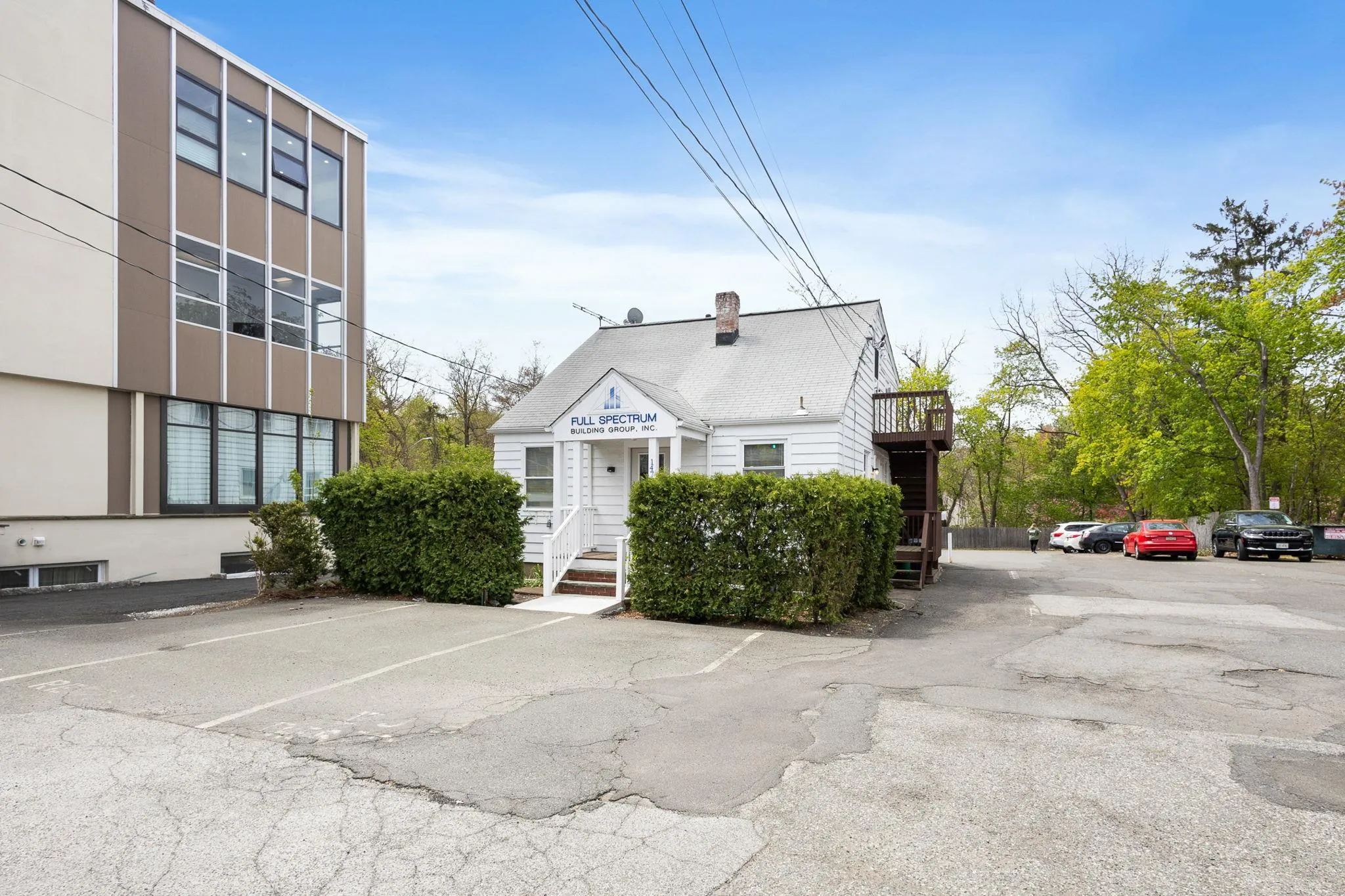 View of building exterior featuring uncovered parking View of building exterior featuring uncovered parking