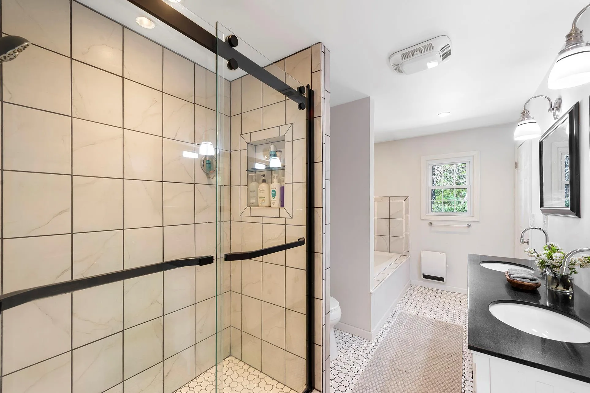 Bathroom featuring tile patterned flooring, a shower stall, a garden tub, double vanity, and toilet Bathroom featuring tile patterned flooring, a shower stall, a garden tub, double vanity, and toilet