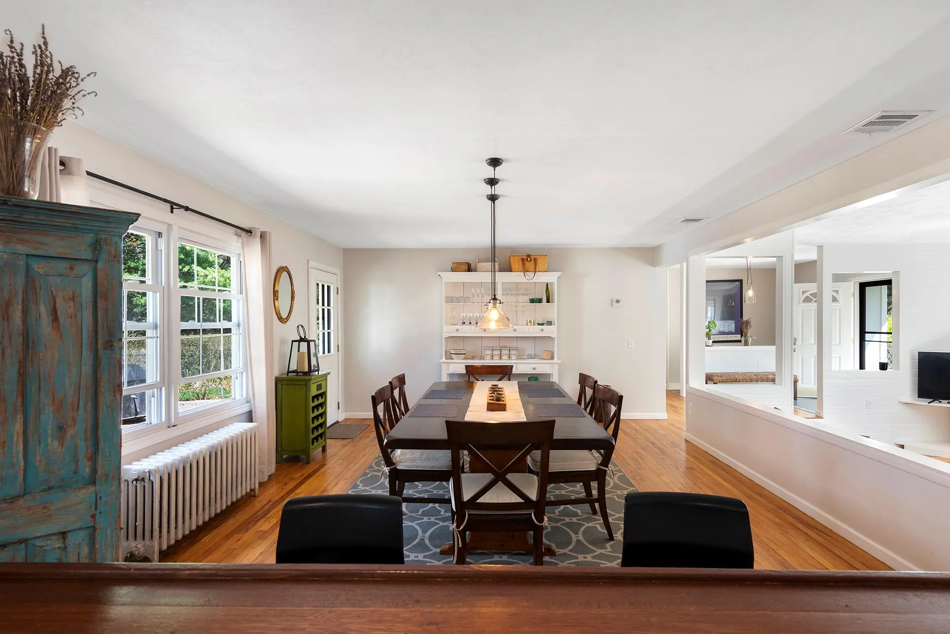 Dining room with radiator, light wood-style floors, and baseboards Dining room with radiator, light wood-style floors, and baseboards
