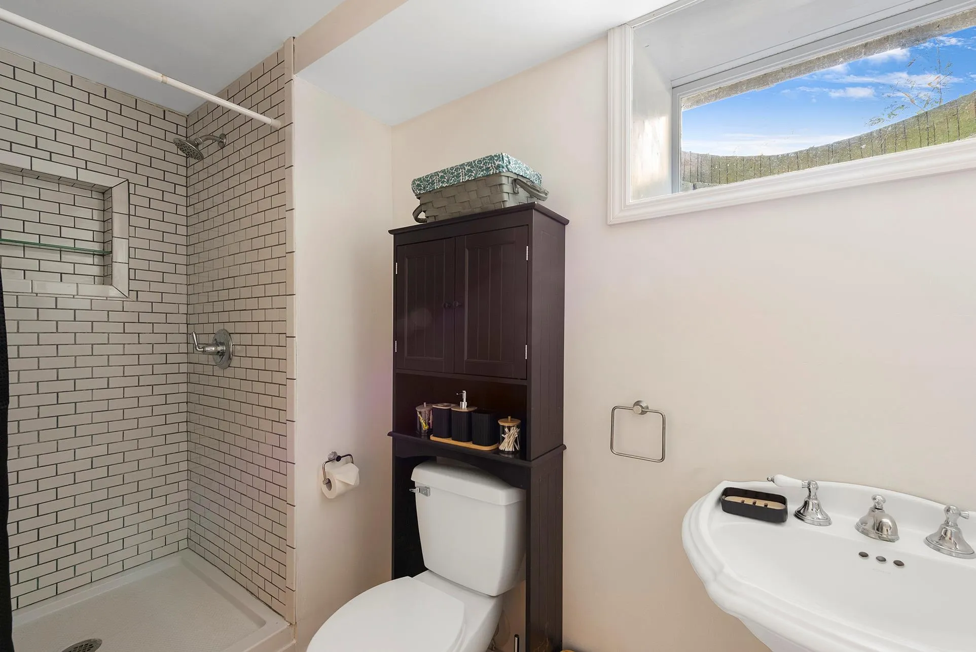 Bathroom featuring a stall shower, toilet, and a sink Bathroom featuring a stall shower, toilet, and a sink