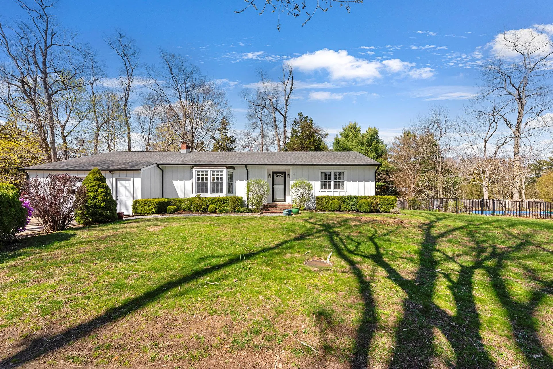View of front facade with board and batten siding and a chimney View of front facade with board and batten siding and a chimney