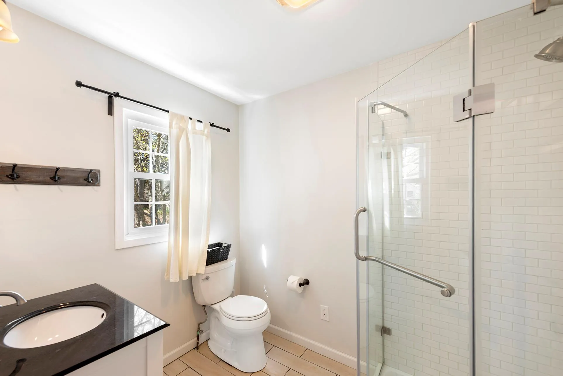 Full bath with a shower stall, tile patterned floors, toilet, vanity, and baseboards Full bath with a shower stall, tile patterned floors, toilet, vanity, and baseboards