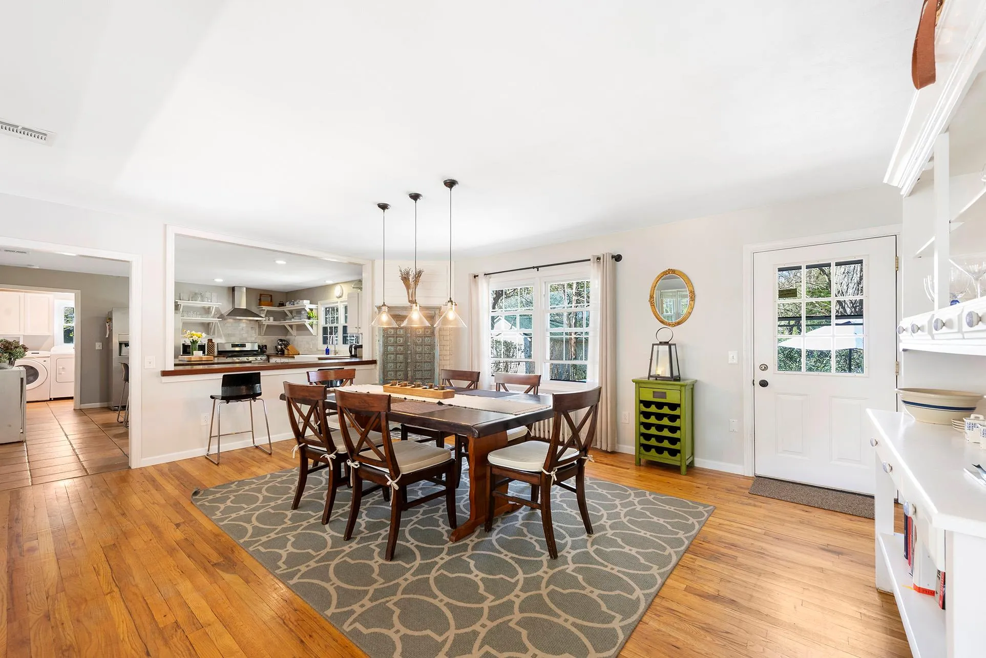 Dining area with washer / clothes dryer, light wood finished floors, plenty of natural light, and baseboards Dining area with washer / clothes dryer, light wood finished floors, plenty of natural light, and baseboards