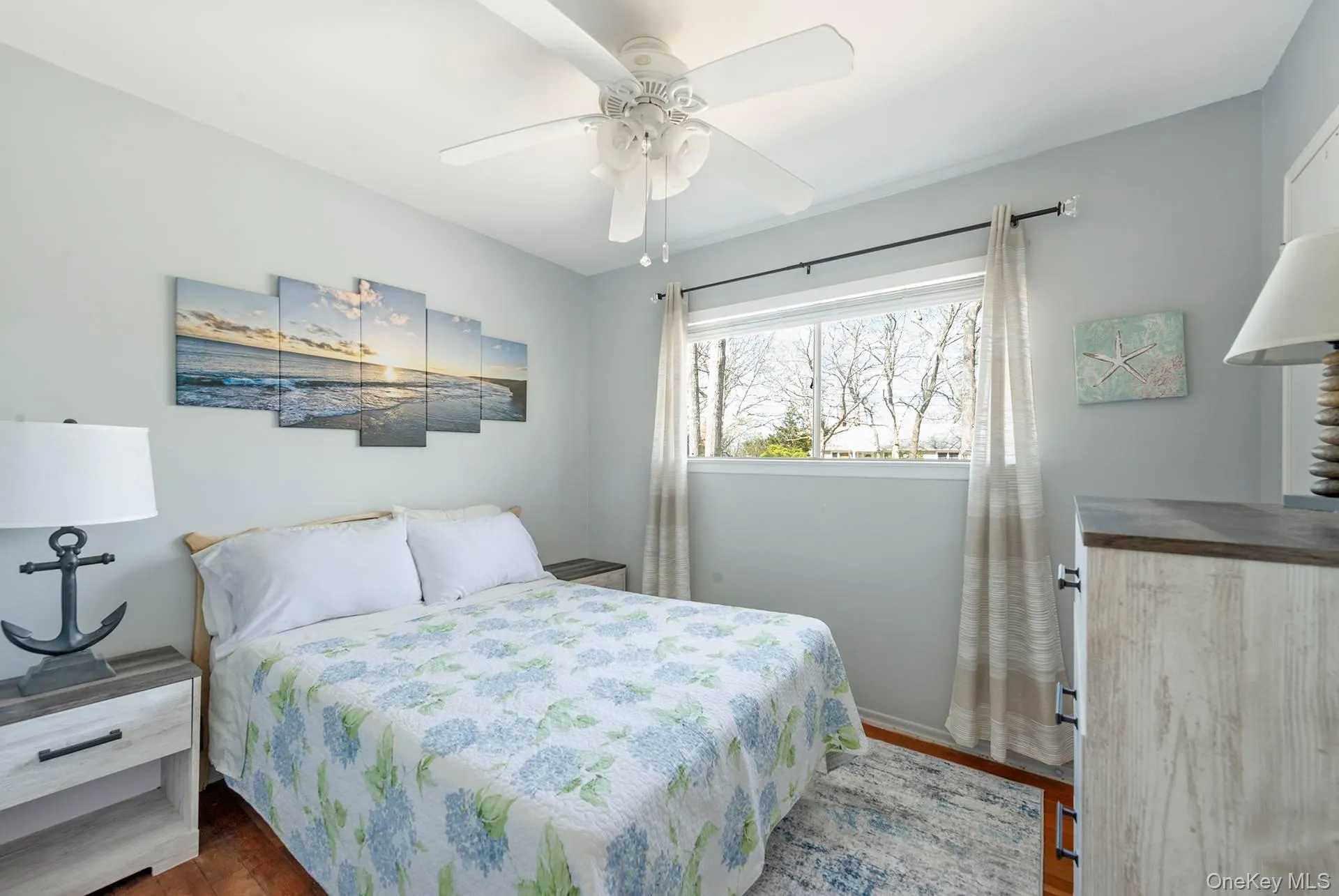 Bedroom with baseboards, ceiling fan, and wood finished floors Bedroom with baseboards, ceiling fan, and wood finished floors