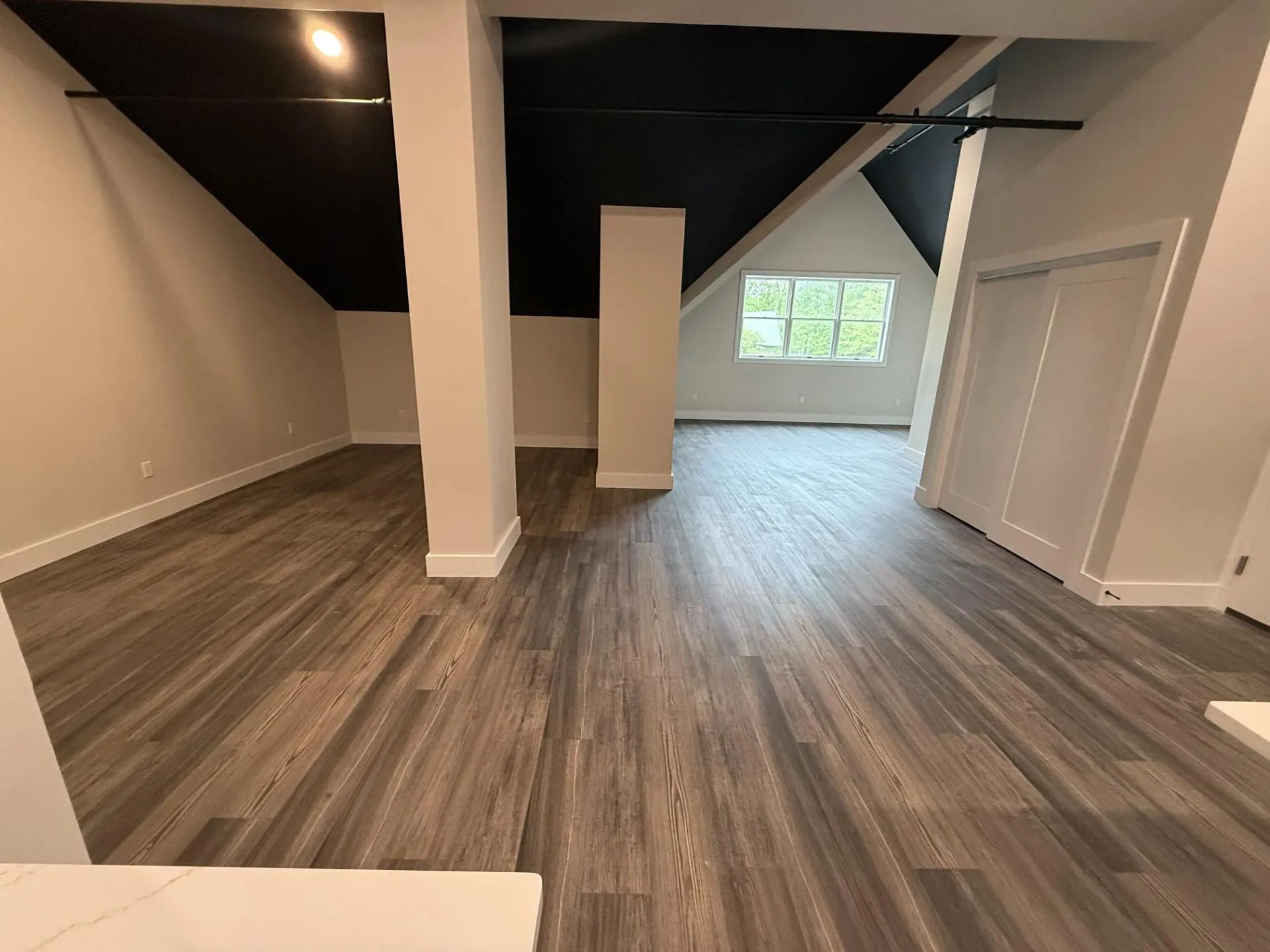 Bonus room featuring vaulted ceiling, dark wood-type flooring, and baseboards Bonus room featuring vaulted ceiling, dark wood-type flooring, and baseboards
