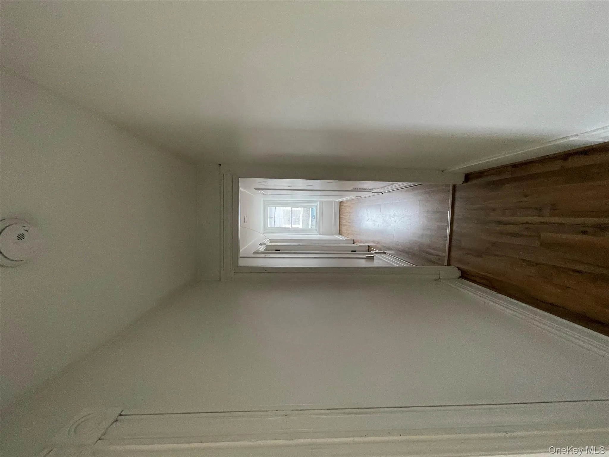 Hall with baseboards and dark wood finished floors Hall with baseboards and dark wood finished floors