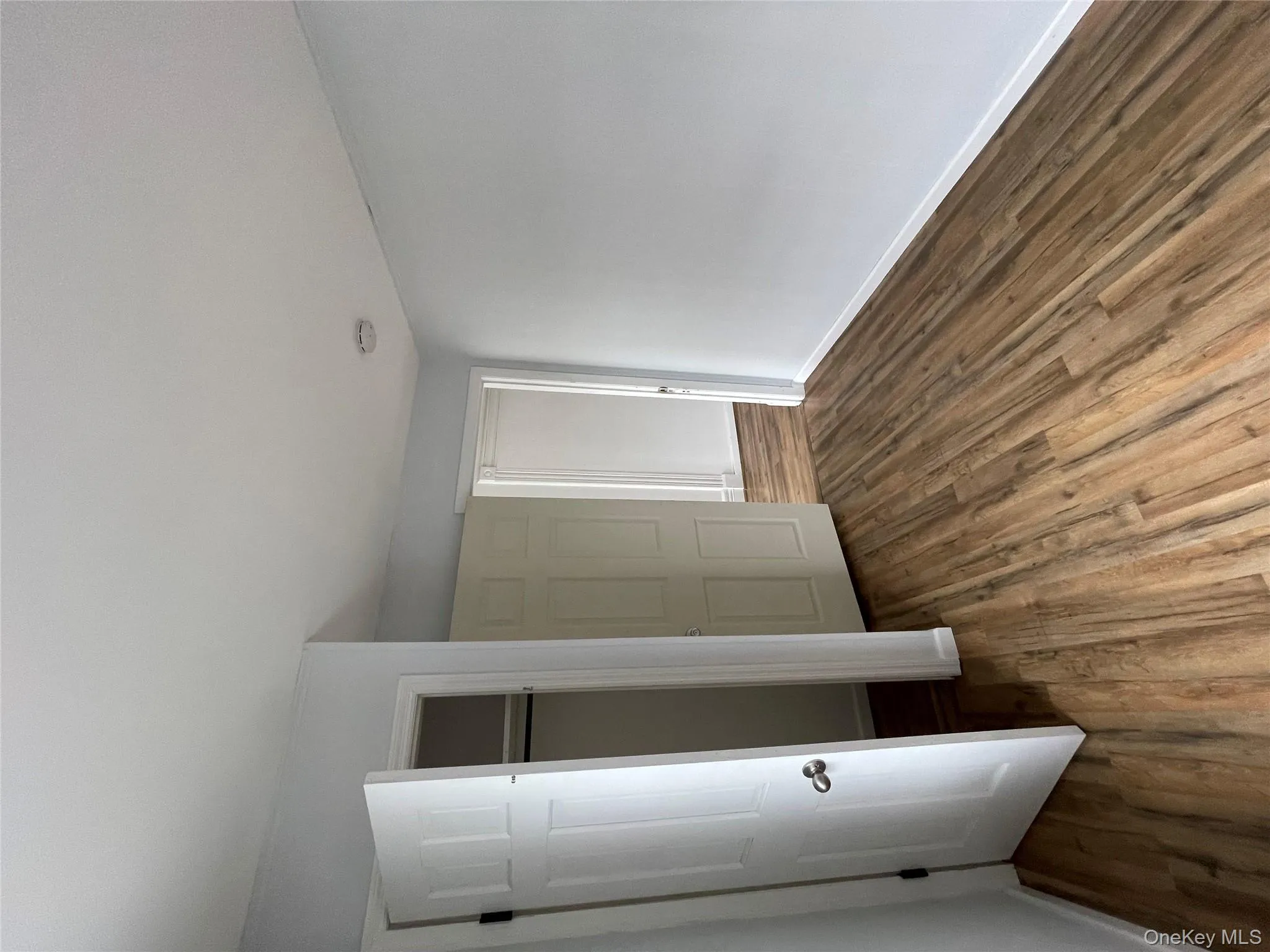 Unfurnished bedroom with baseboards, a closet, and wood finished floors Unfurnished bedroom with baseboards, a closet, and wood finished floors