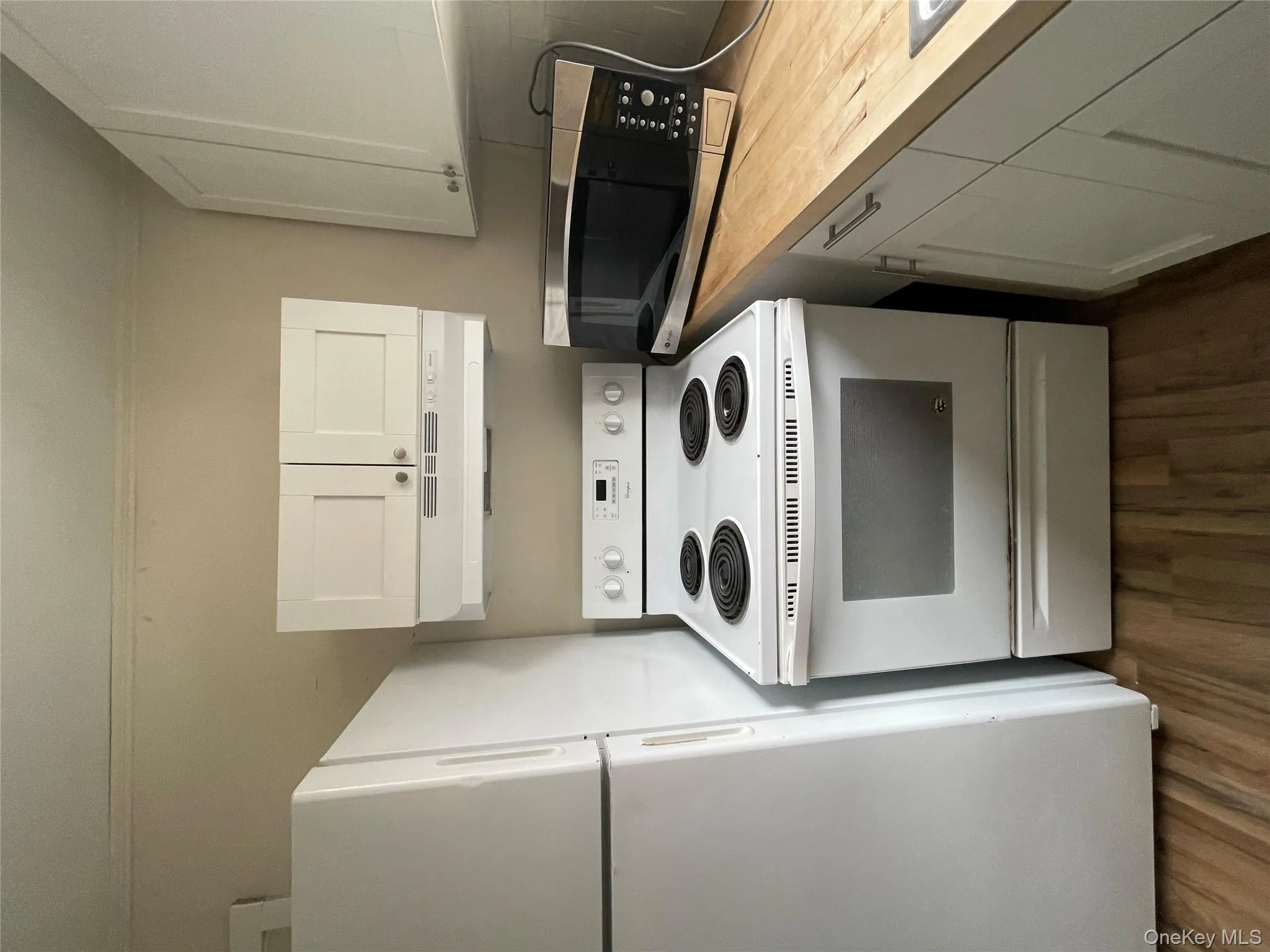 Kitchen with extractor fan, wooden counters, dark wood finished floors, electric stove, and refrigerator Kitchen with extractor fan, wooden counters, dark wood finished floors, electric stove, and refrigerator