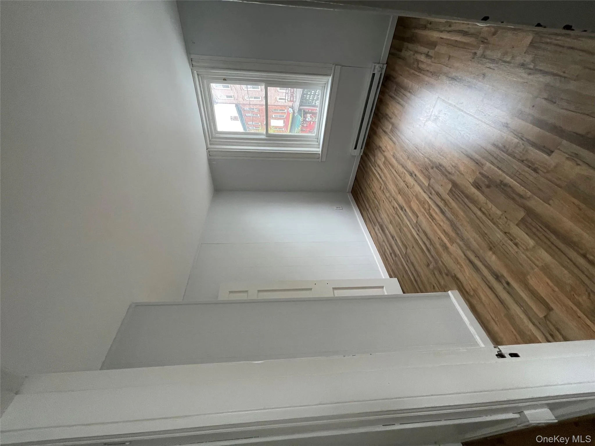 Spare room featuring baseboards, a baseboard heating unit, and dark wood finished floors Spare room featuring baseboards, a baseboard heating unit, and dark wood finished floors