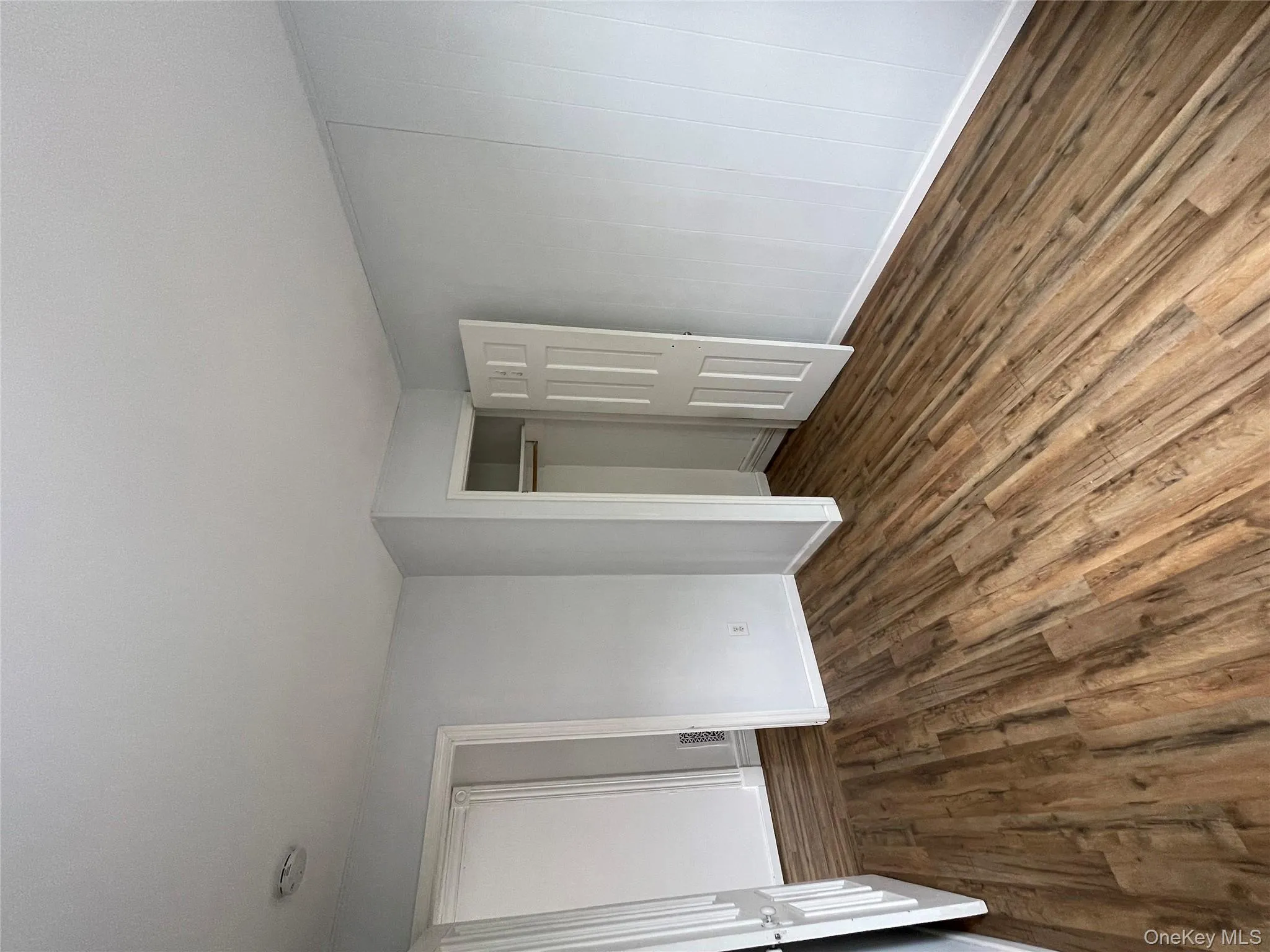 Unfurnished bedroom featuring dark wood-type flooring, baseboards, and a closet Unfurnished bedroom featuring dark wood-type flooring, baseboards, and a closet