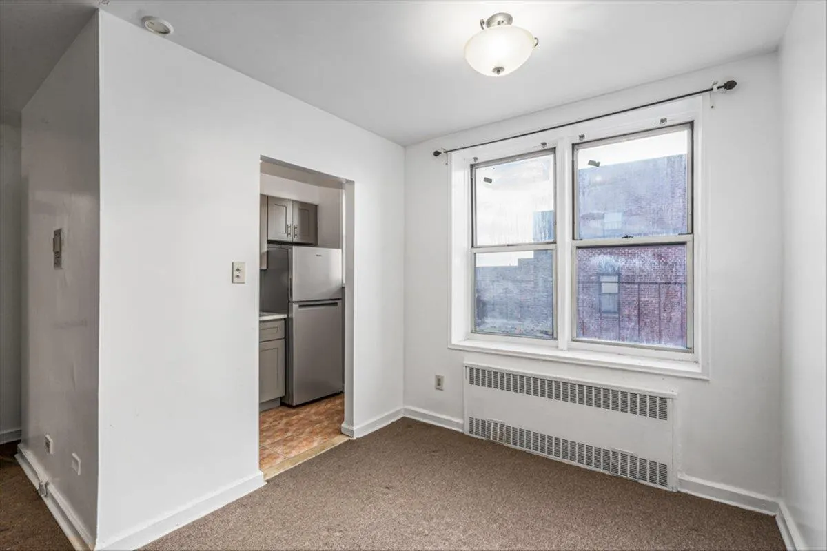 Carpeted spare room with radiator Carpeted spare room with radiator