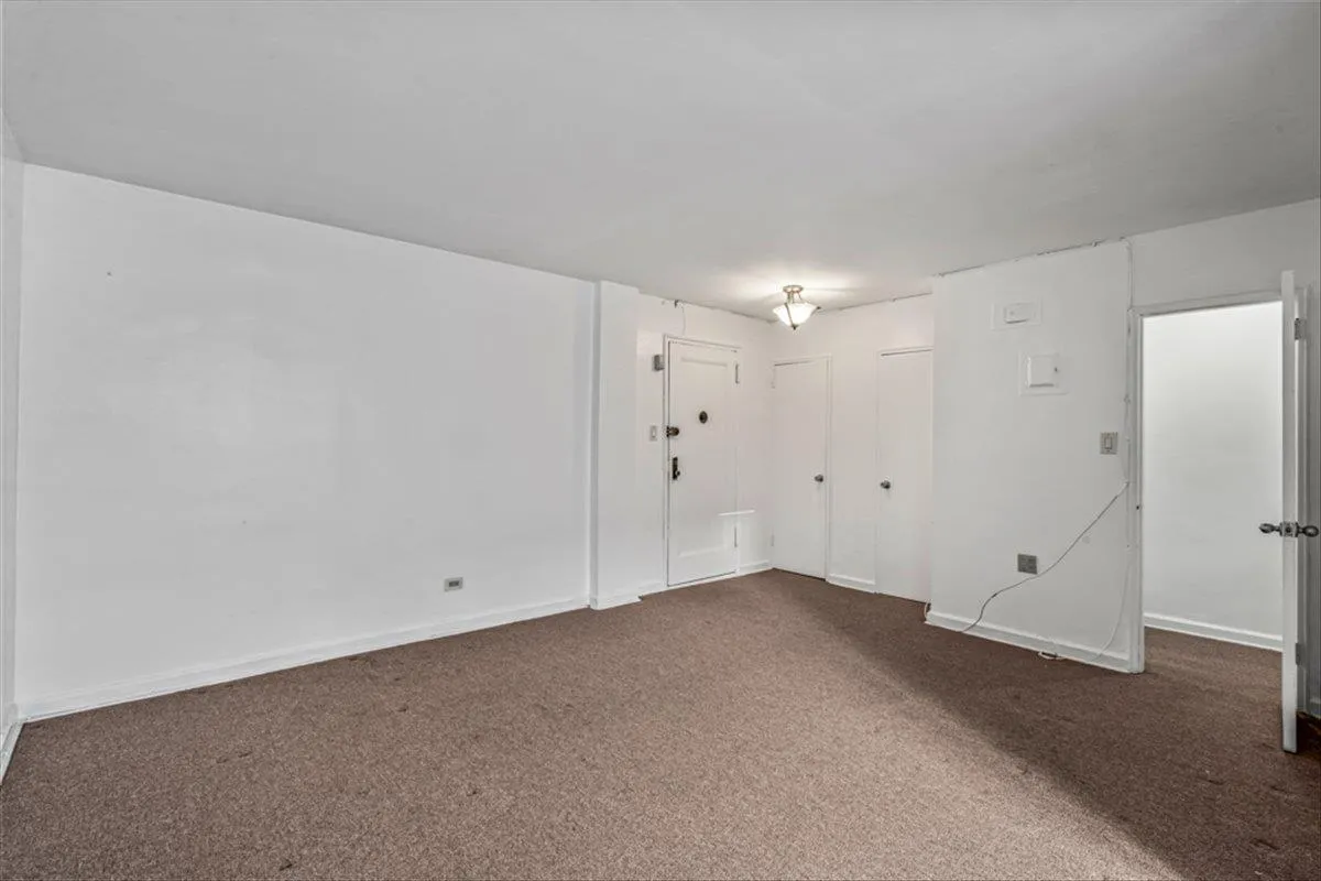 Spare room featuring dark carpet Spare room featuring dark carpet