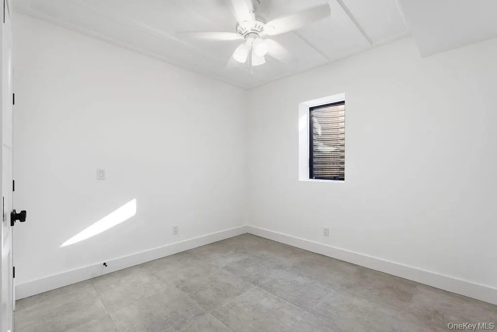 Unfurnished room featuring baseboards and ceiling fan Unfurnished room featuring baseboards and ceiling fan