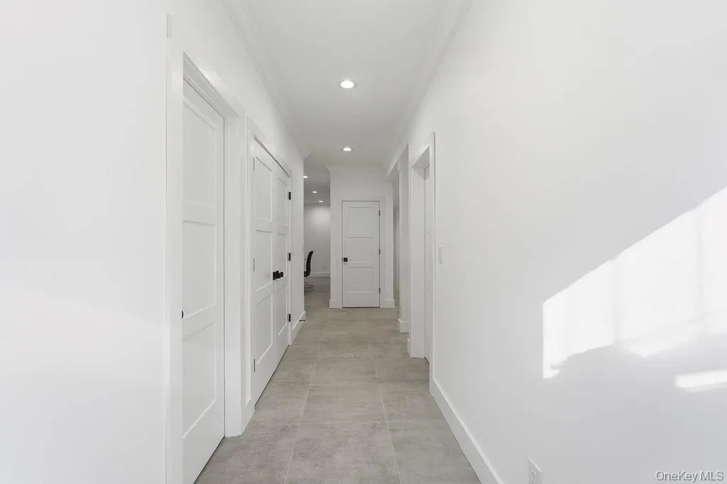 Hall featuring crown molding and recessed lighting Hall featuring crown molding and recessed lighting