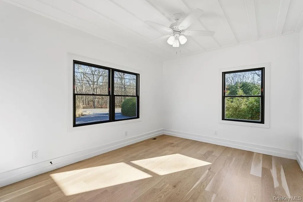 Spare room with light wood-style floors and a ceiling fan Spare room with light wood-style floors and a ceiling fan