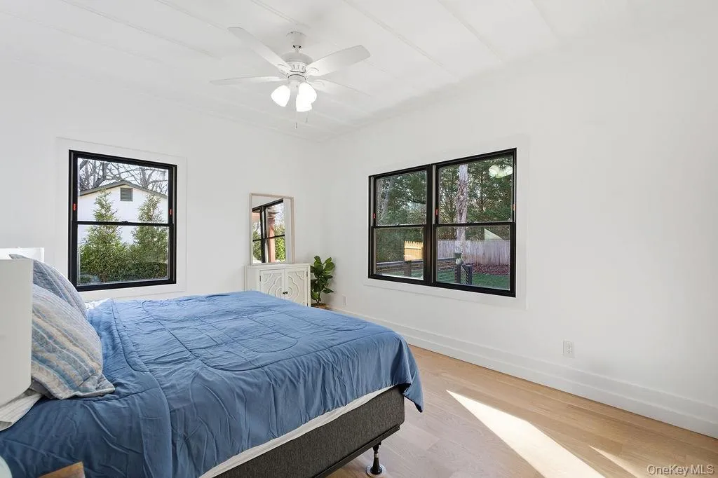 Bedroom with wood finished floors and a ceiling fan Bedroom with wood finished floors and a ceiling fan
