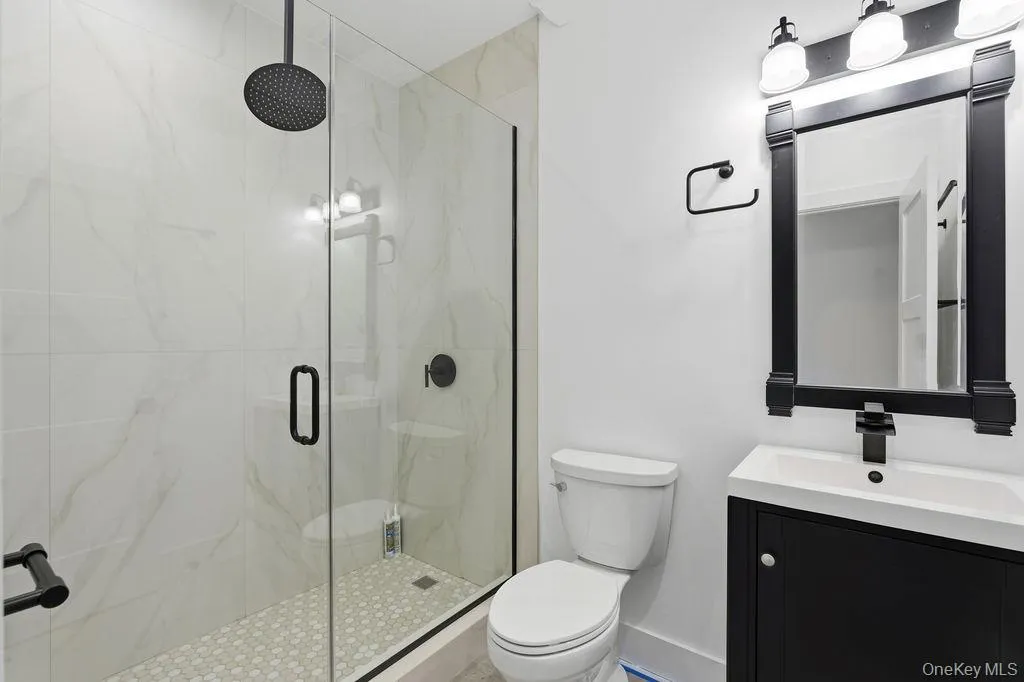 Bathroom with a marble finish shower and vanity Bathroom with a marble finish shower and vanity