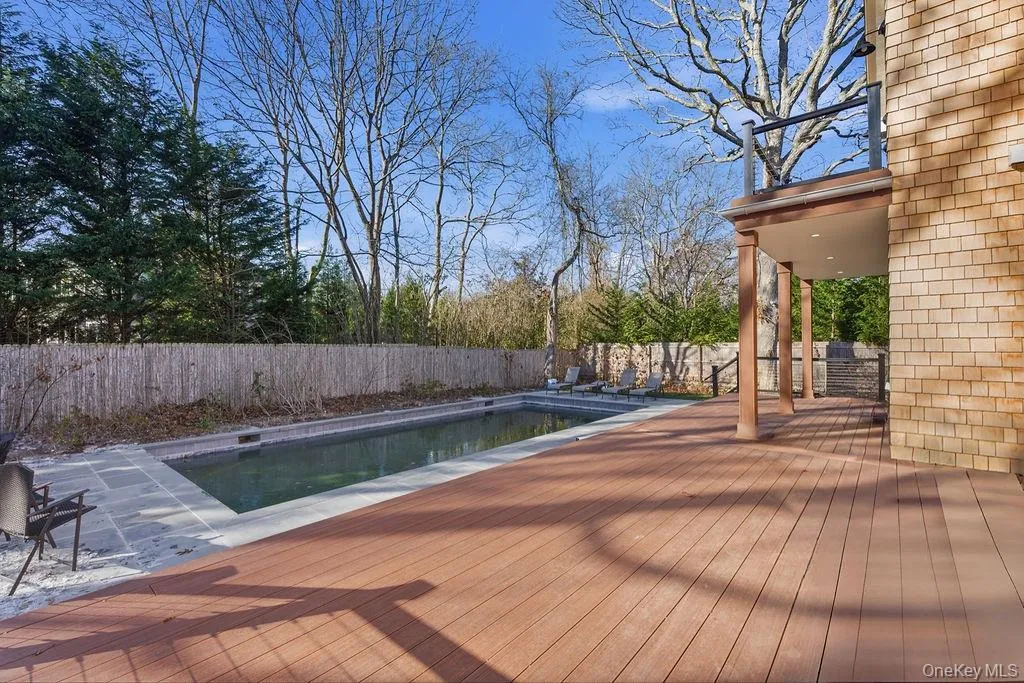 View of pool with a fenced backyard, a wooden deck, and a patio View of pool with a fenced backyard, a wooden deck, and a patio