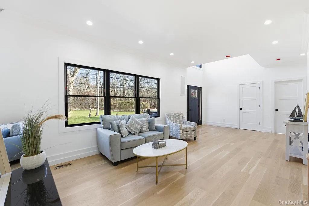 Living room featuring light wood-style floors and recessed lighting Living room featuring light wood-style floors and recessed lighting