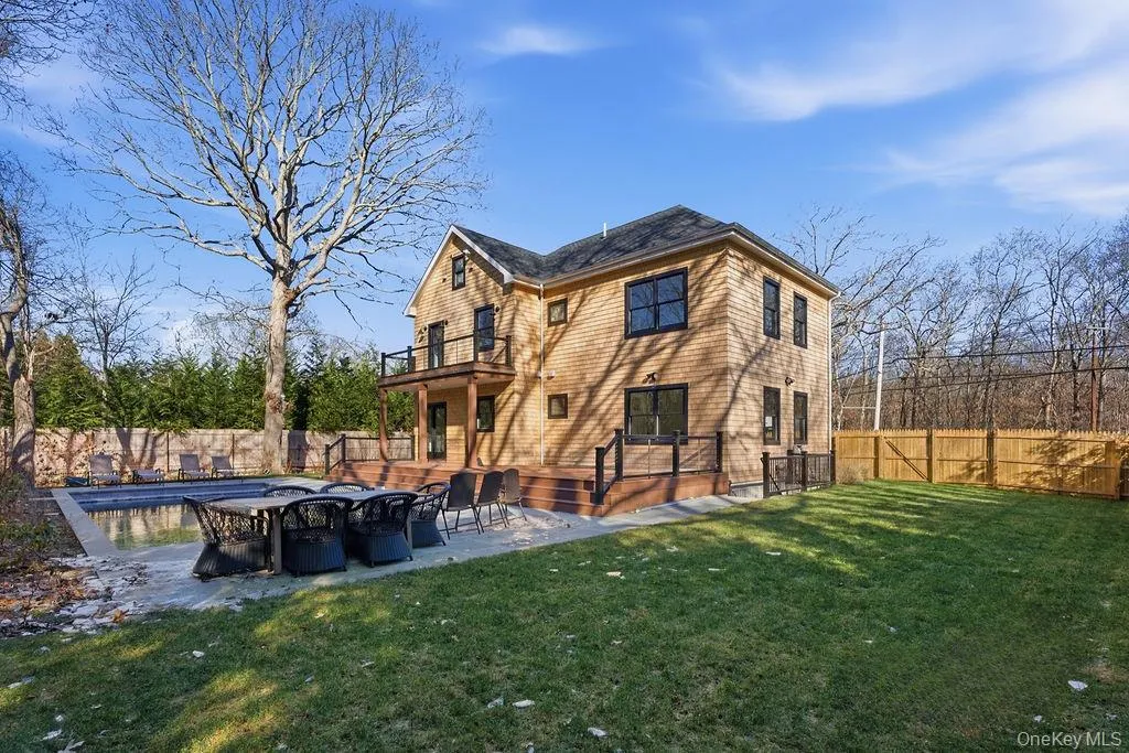 Back of house with a fenced backyard, a patio, and a wooden deck Back of house with a fenced backyard, a patio, and a wooden deck