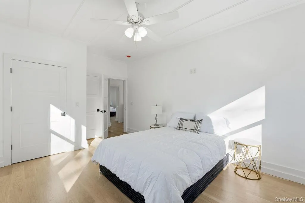 Bedroom featuring light wood-style floors and a ceiling fan Bedroom featuring light wood-style floors and a ceiling fan