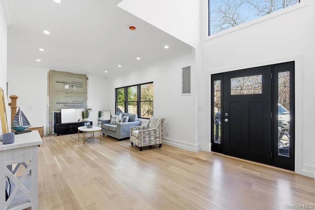Entryway with recessed lighting, light wood-style floors, and ornamental molding Entryway with recessed lighting, light wood-style floors, and ornamental molding
