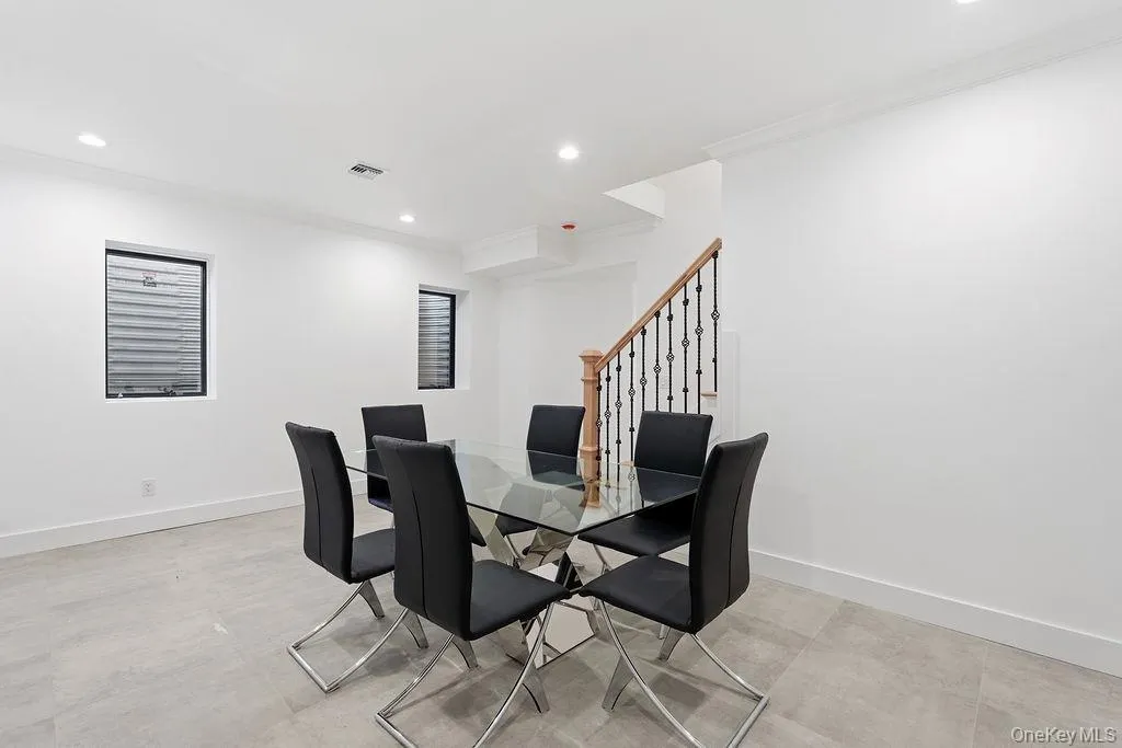 Dining area with ornamental molding, recessed lighting, and stairway Dining area with ornamental molding, recessed lighting, and stairway
