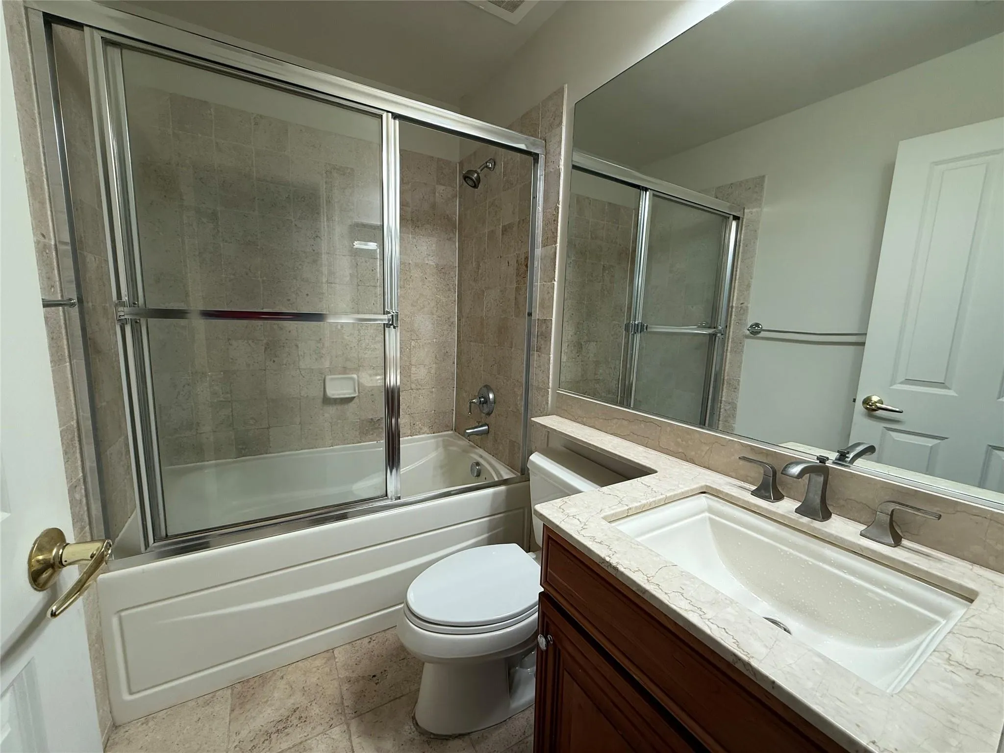 Full bath with toilet, combined bath / shower with glass door, and vanity Full bath with toilet, combined bath / shower with glass door, and vanity