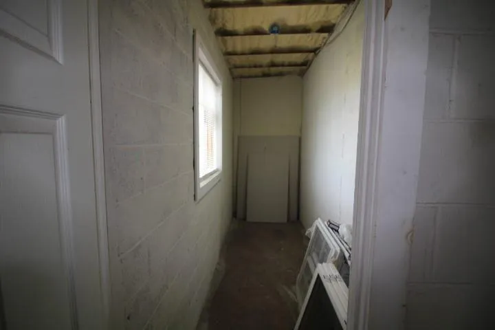Hallway featuring heating unit and concrete flooring Hallway featuring heating unit and concrete flooring