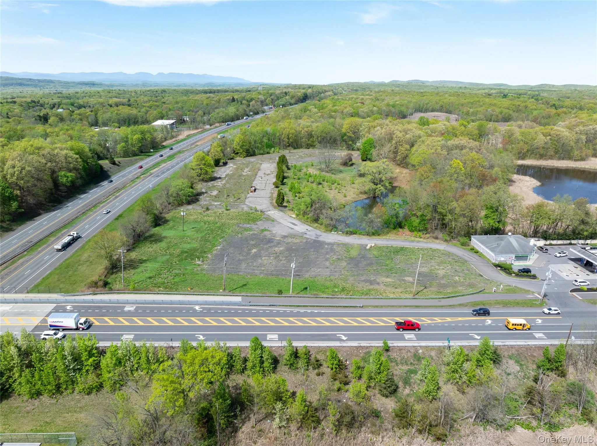 Birds eye view of property featuring a water view and a wooded view Birds eye view of property featuring a water view and a wooded view