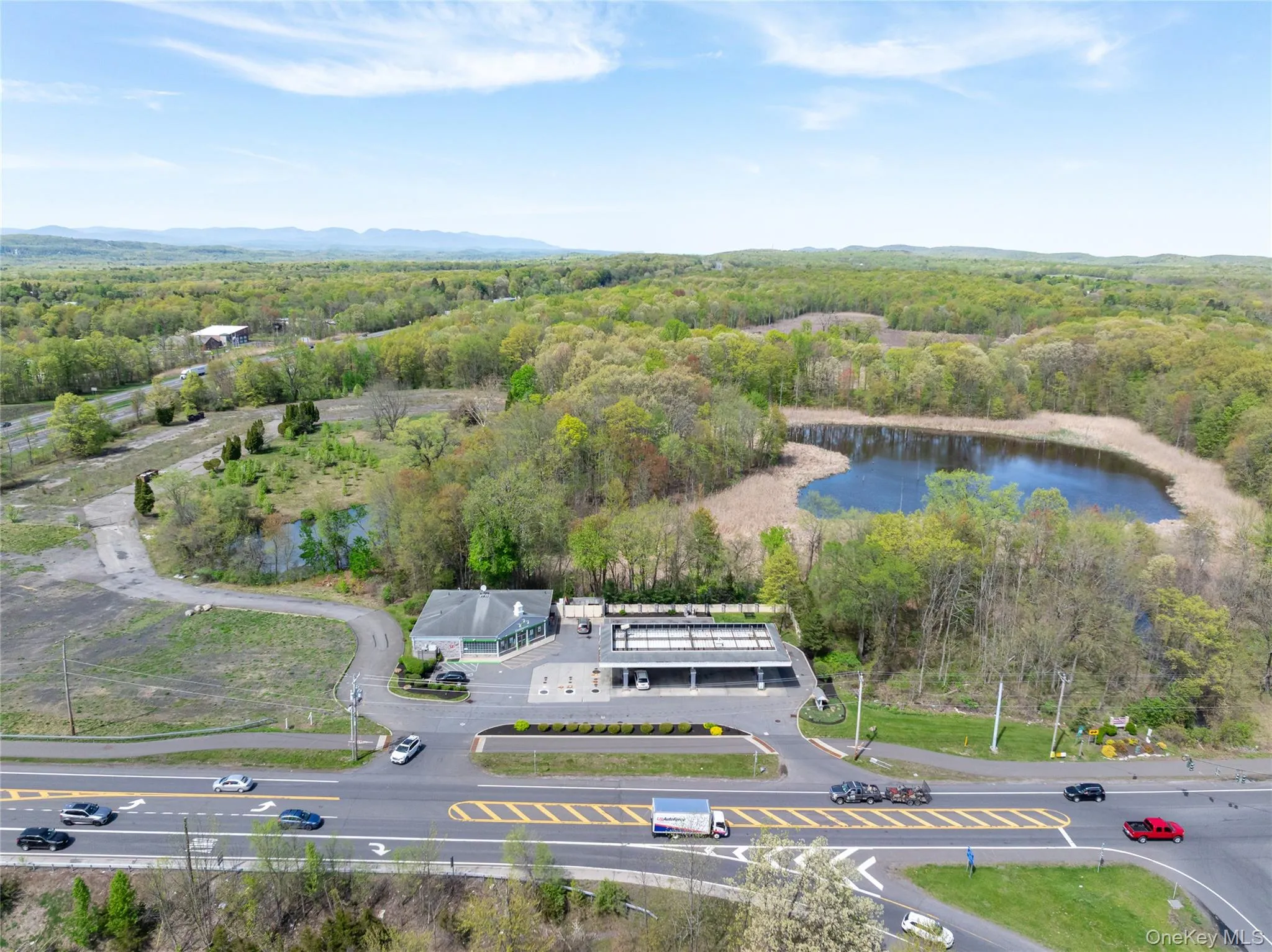 Drone / aerial view featuring a water and mountain view and a wooded view Drone / aerial view featuring a water and mountain view and a wooded view