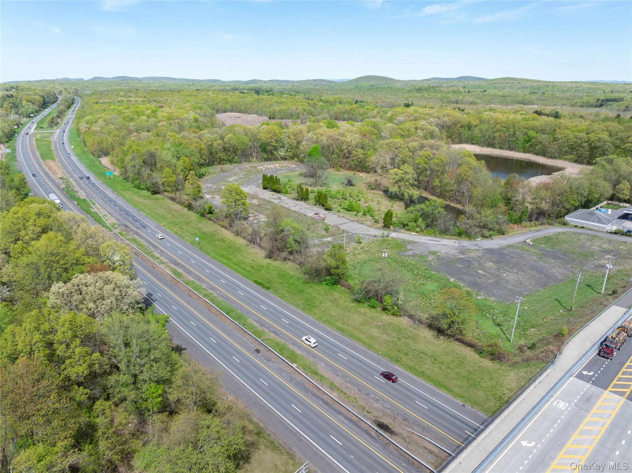 Birds eye view of property featuring a water view and a forest view Birds eye view of property featuring a water view and a forest view