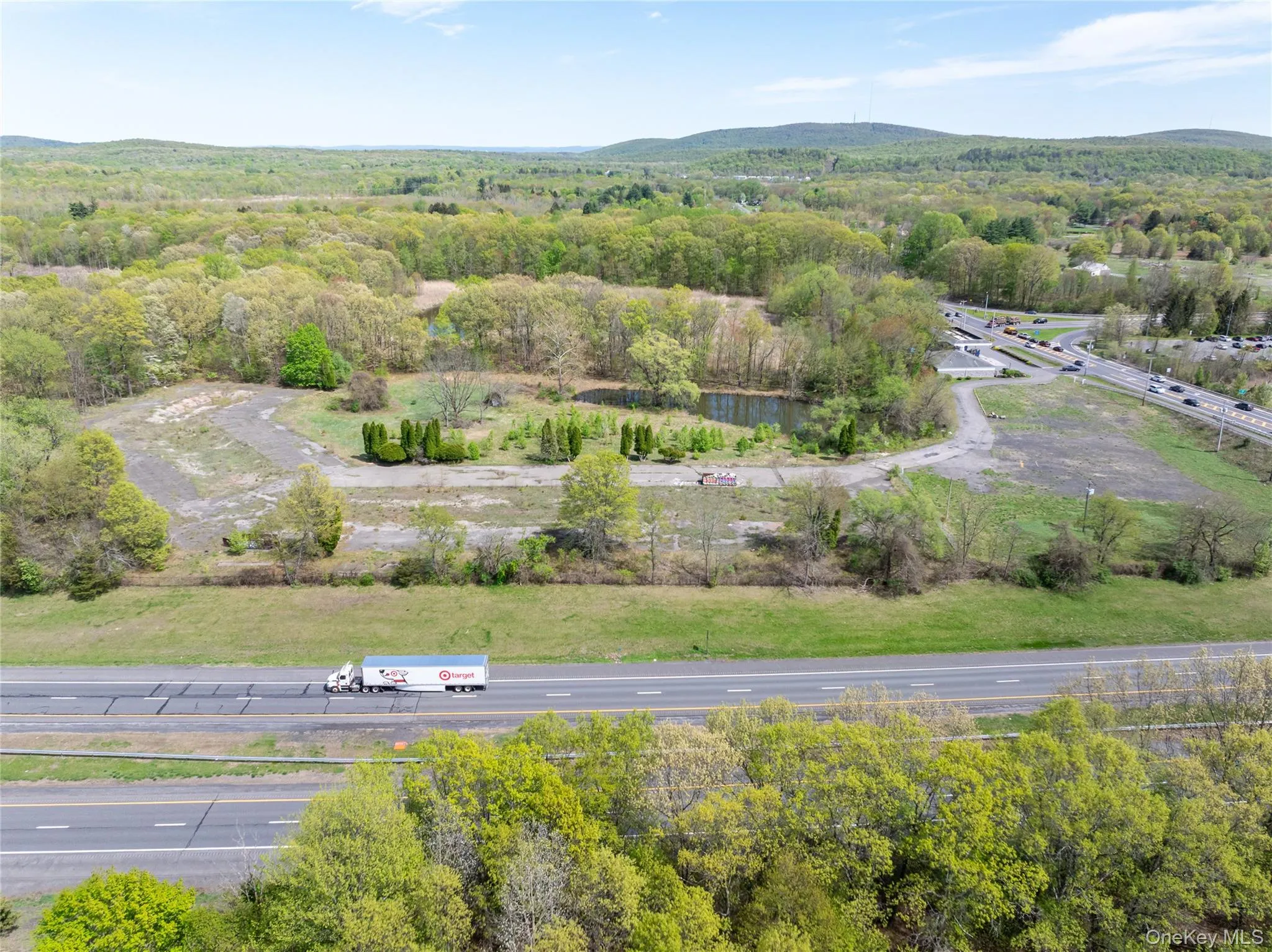 Birds eye view of property with a view of trees and a mountain view Birds eye view of property with a view of trees and a mountain view