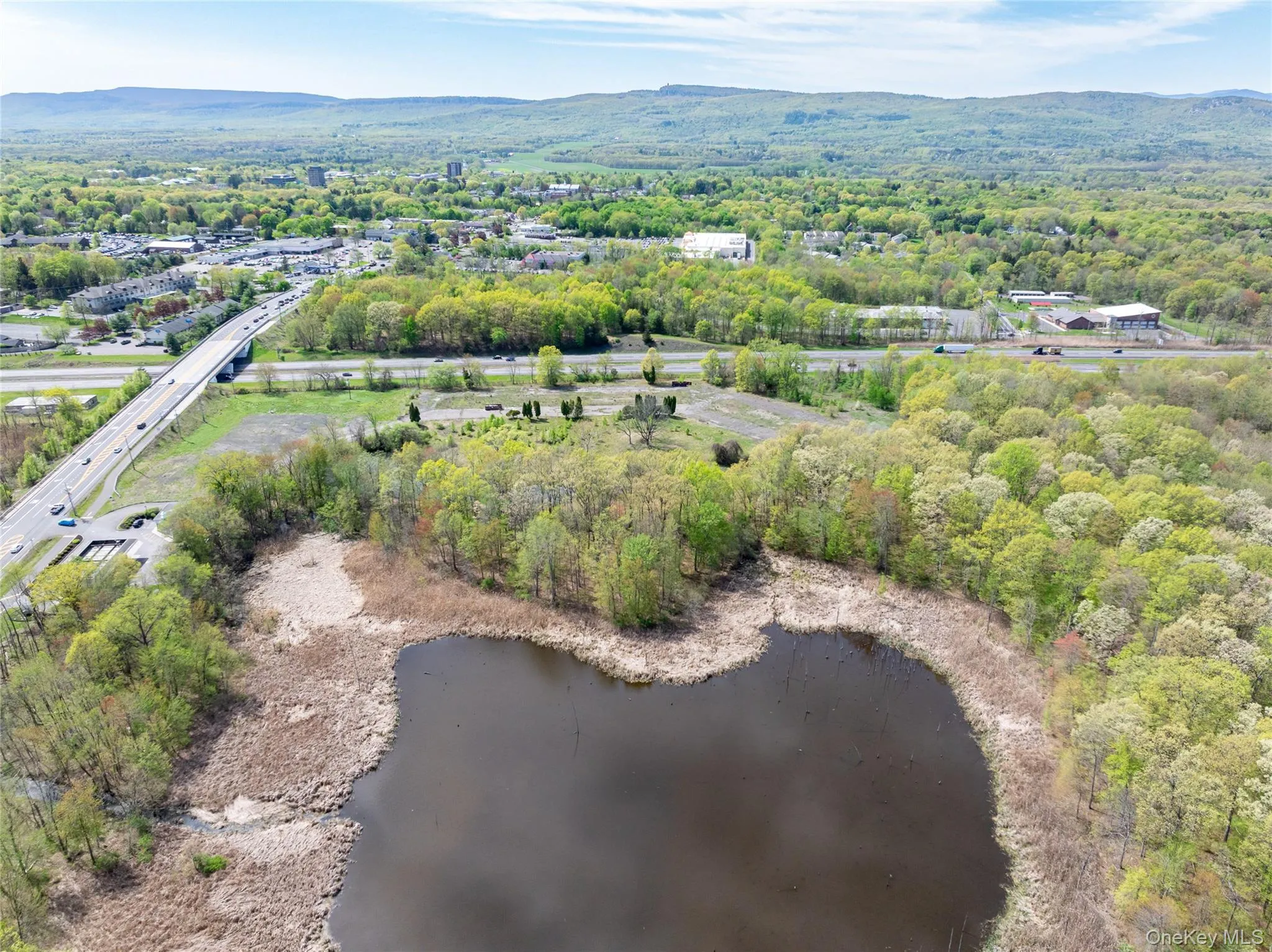 Birds eye view of property with a water and mountain view and a wooded view Birds eye view of property with a water and mountain view and a wooded view