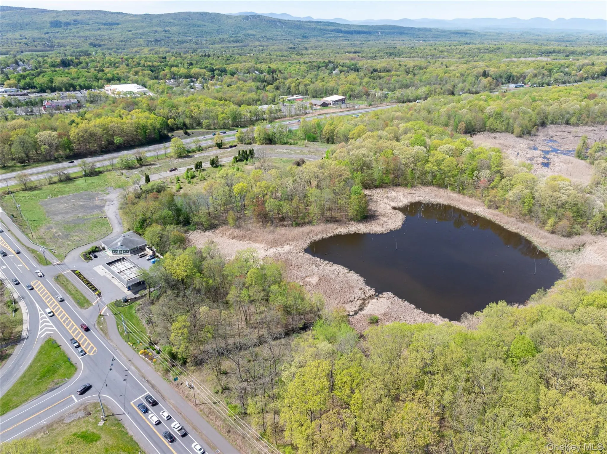 Bird's eye view with a water and mountain view and a forest view Bird's eye view with a water and mountain view and a forest view