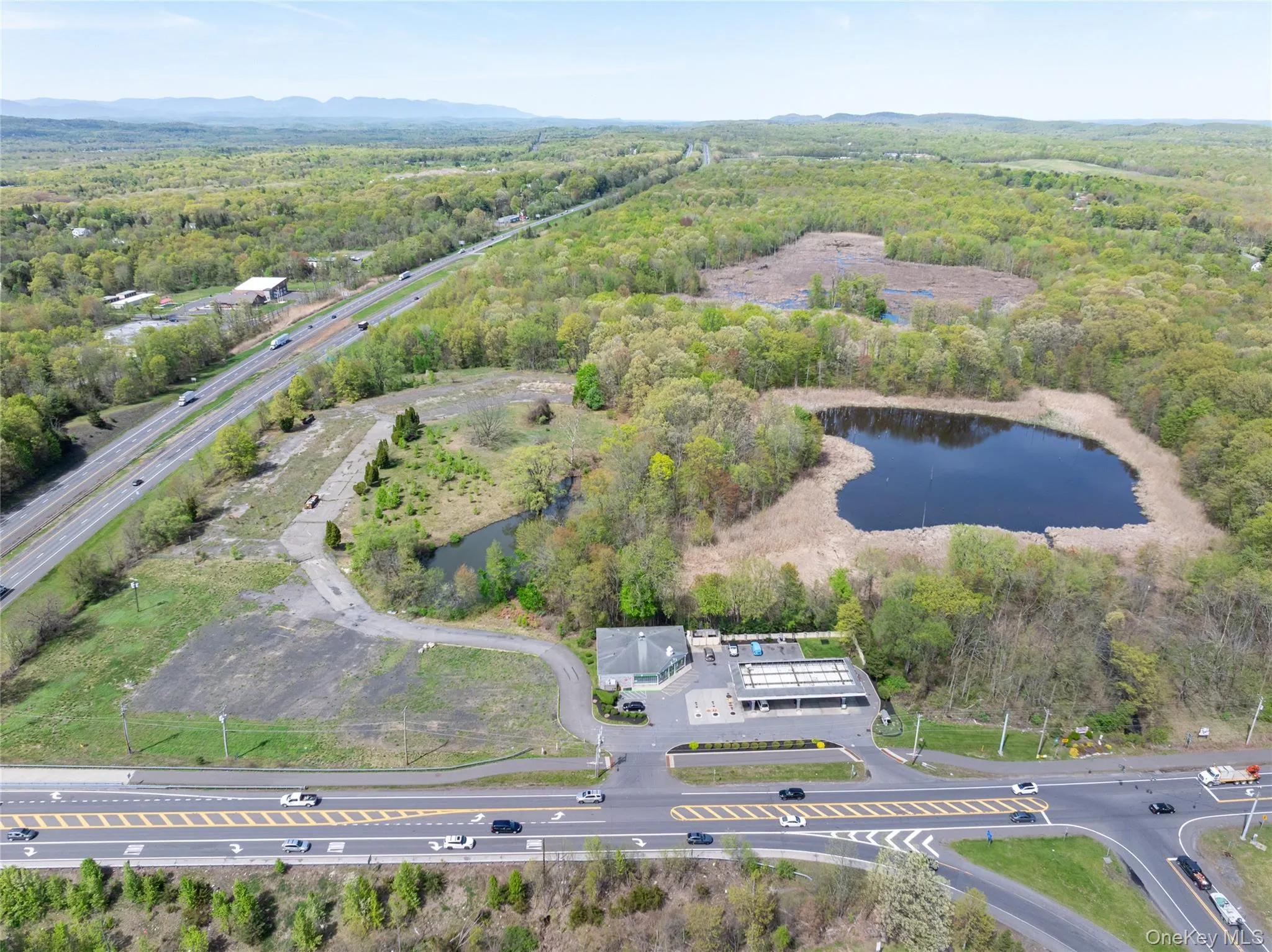 Birds eye view of property with a water view and a view of trees Birds eye view of property with a water view and a view of trees