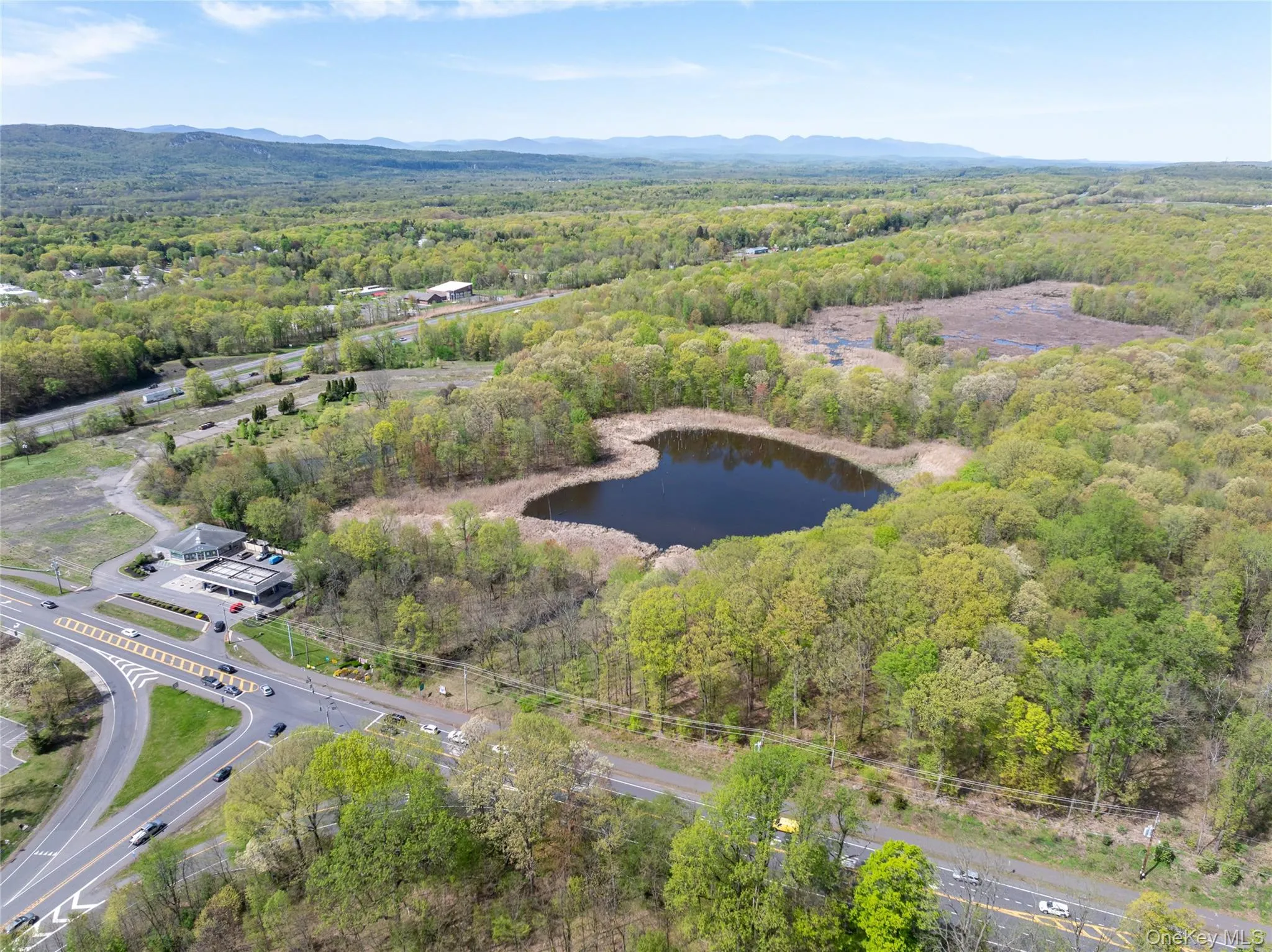 Drone / aerial view with a water and mountain view and a forest view Drone / aerial view with a water and mountain view and a forest view