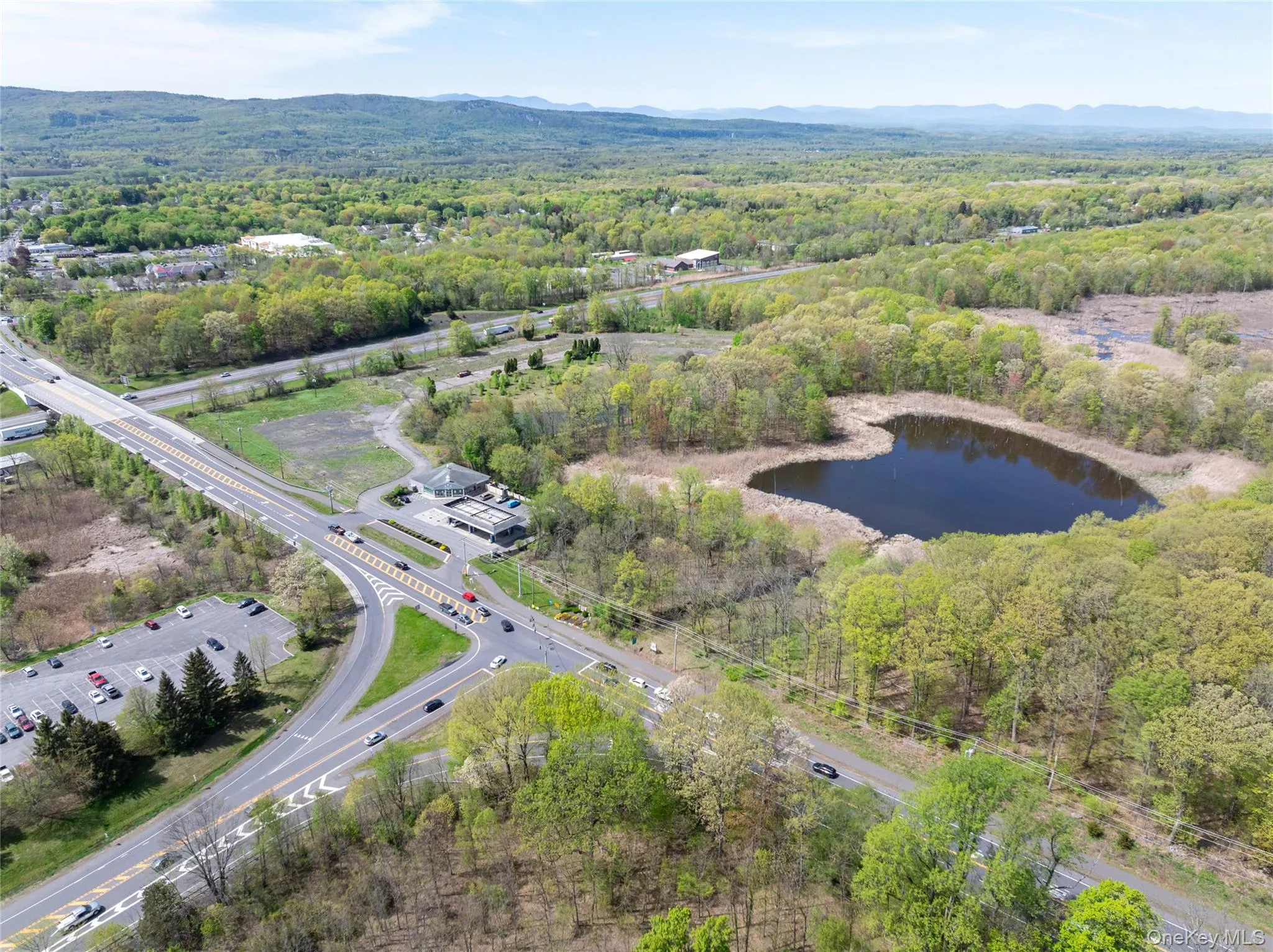 Aerial view featuring a water and mountain view and a forest view Aerial view featuring a water and mountain view and a forest view