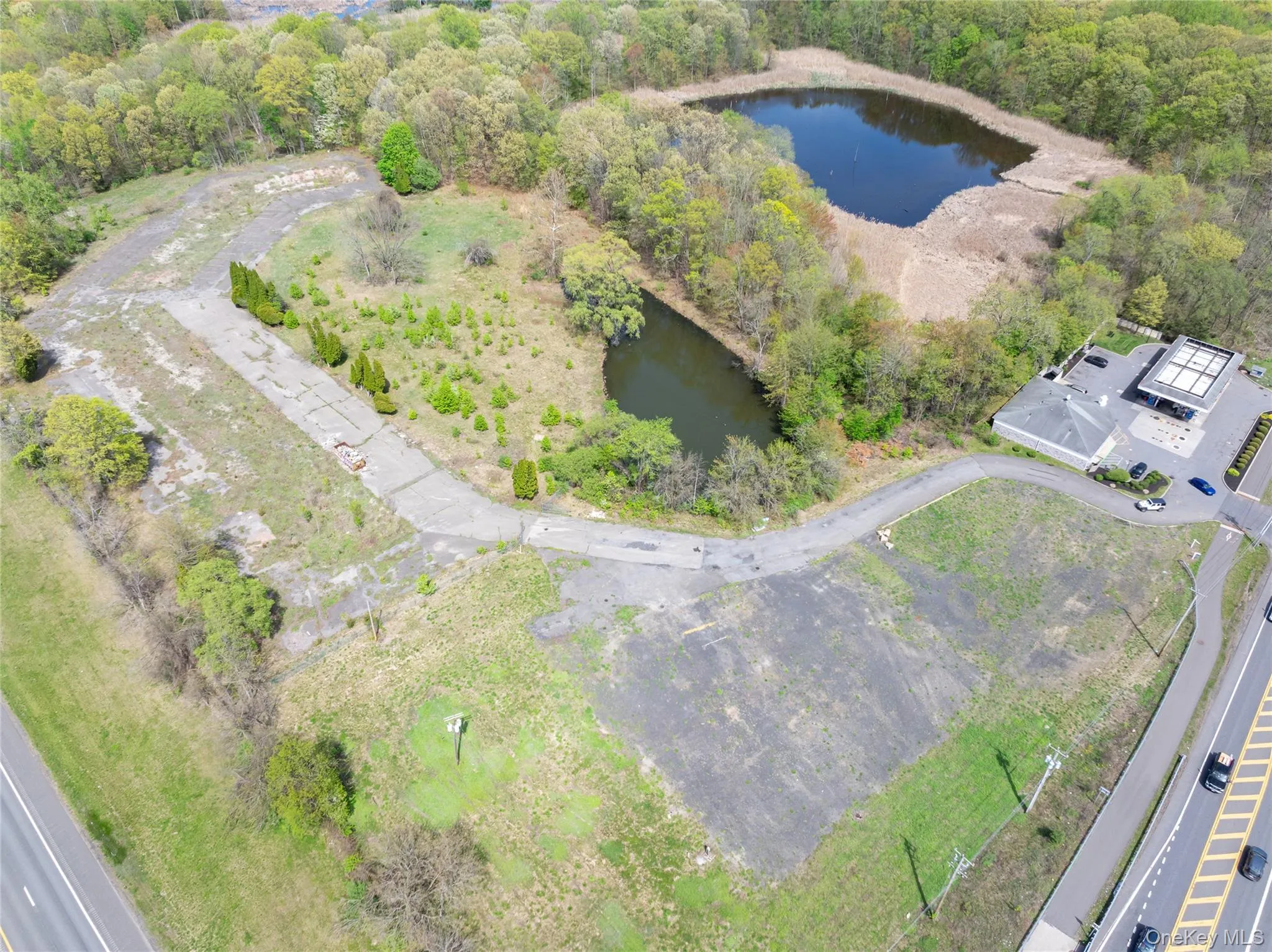 Birds eye view of property featuring a water view and a forest view Birds eye view of property featuring a water view and a forest view