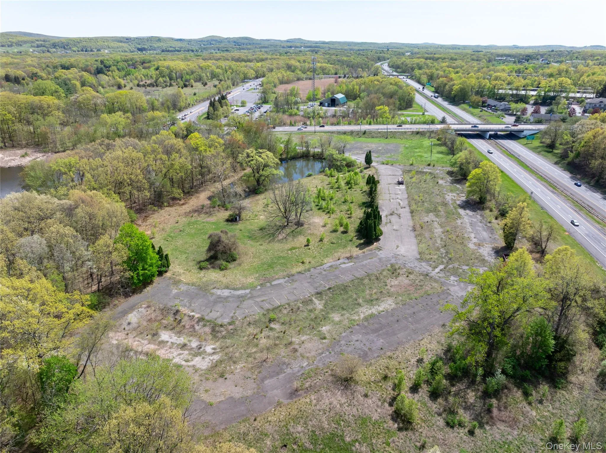 Birds eye view of property featuring a view of trees and a water view Birds eye view of property featuring a view of trees and a water view