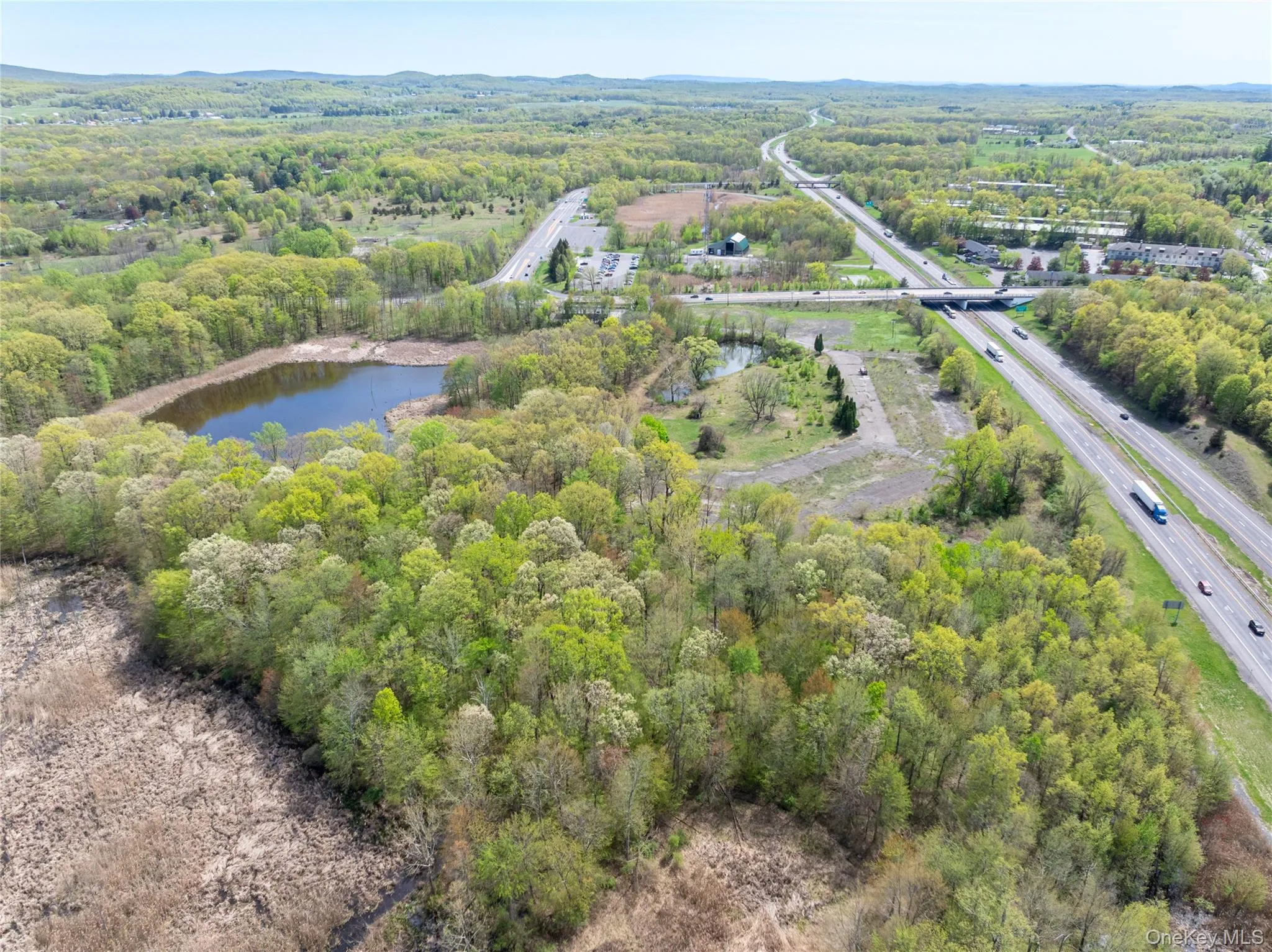 Birds eye view of property with a water view and a view of trees Birds eye view of property with a water view and a view of trees