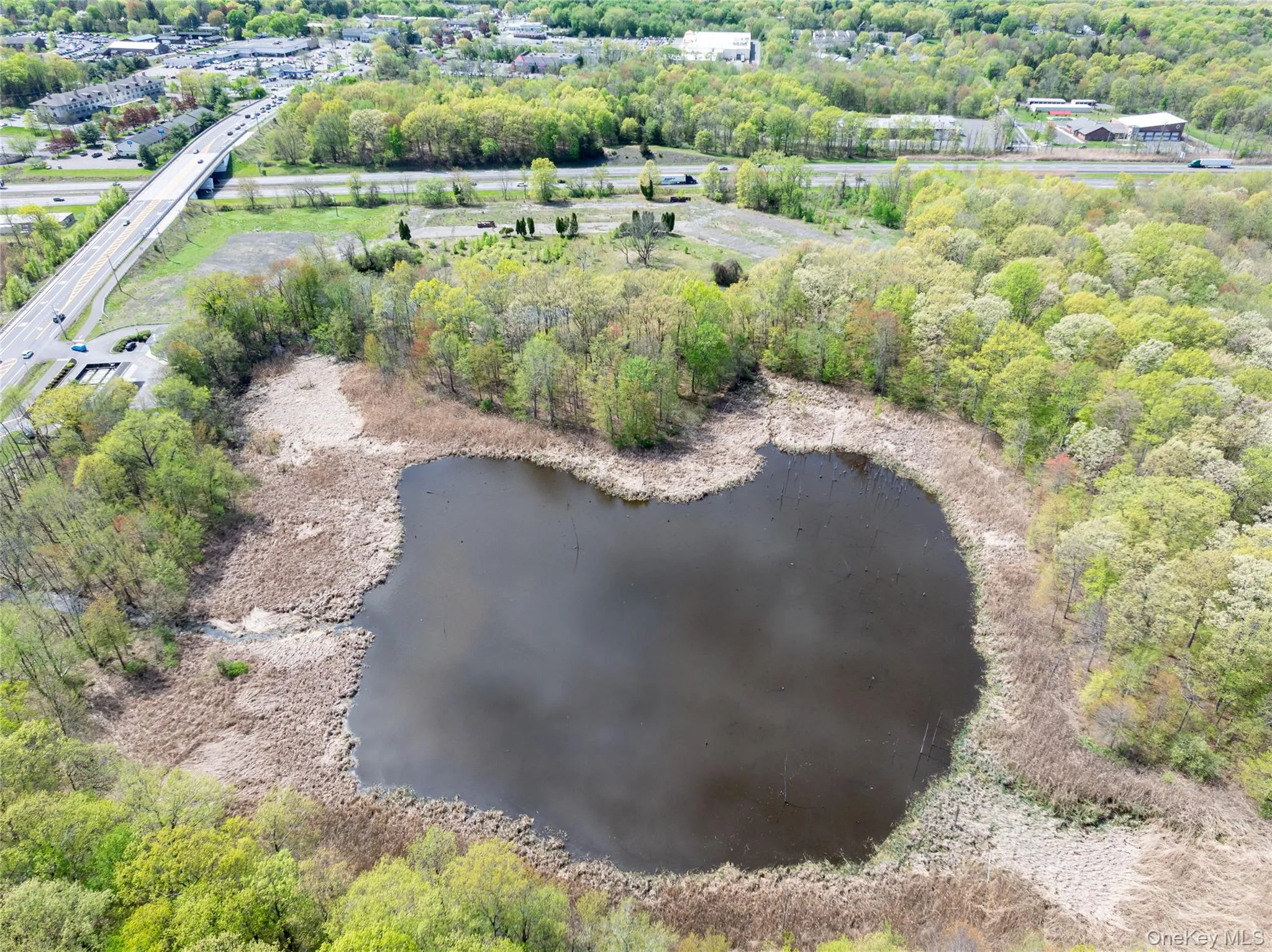 Aerial view featuring a water view and a forest view Aerial view featuring a water view and a forest view