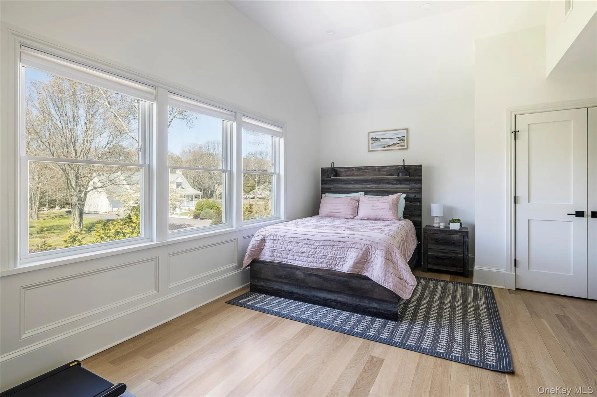 Bedroom with wood finished floors and lofted ceiling Bedroom with wood finished floors and lofted ceiling