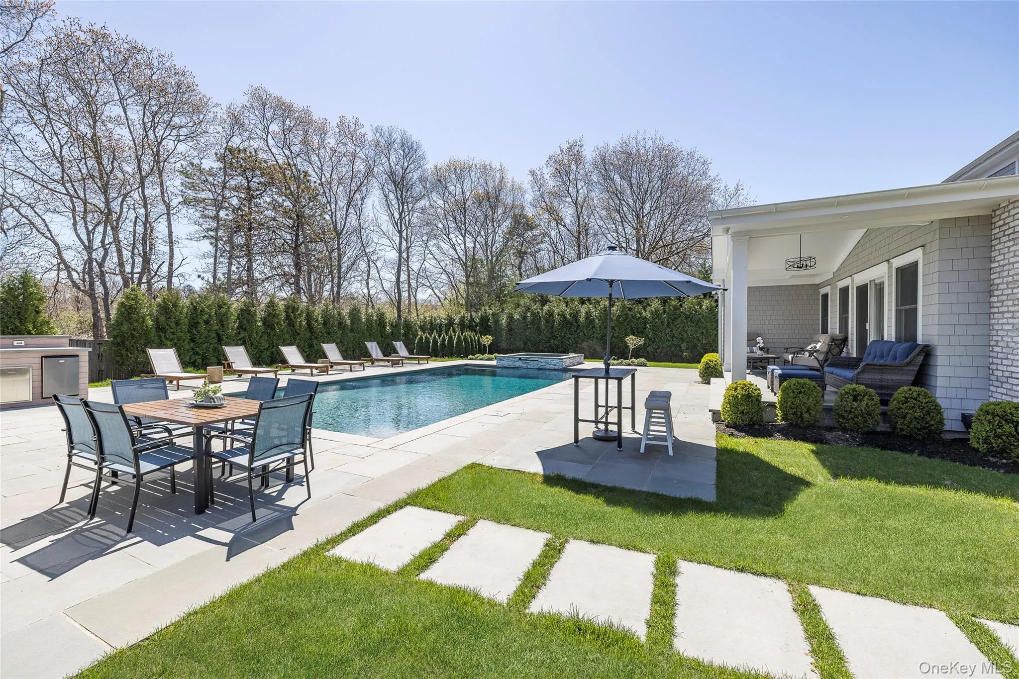 View of swimming pool with a patio, area for grilling, a fenced in pool, an in ground hot tub, and a yard View of swimming pool with a patio, area for grilling, a fenced in pool, an in ground hot tub, and a yard