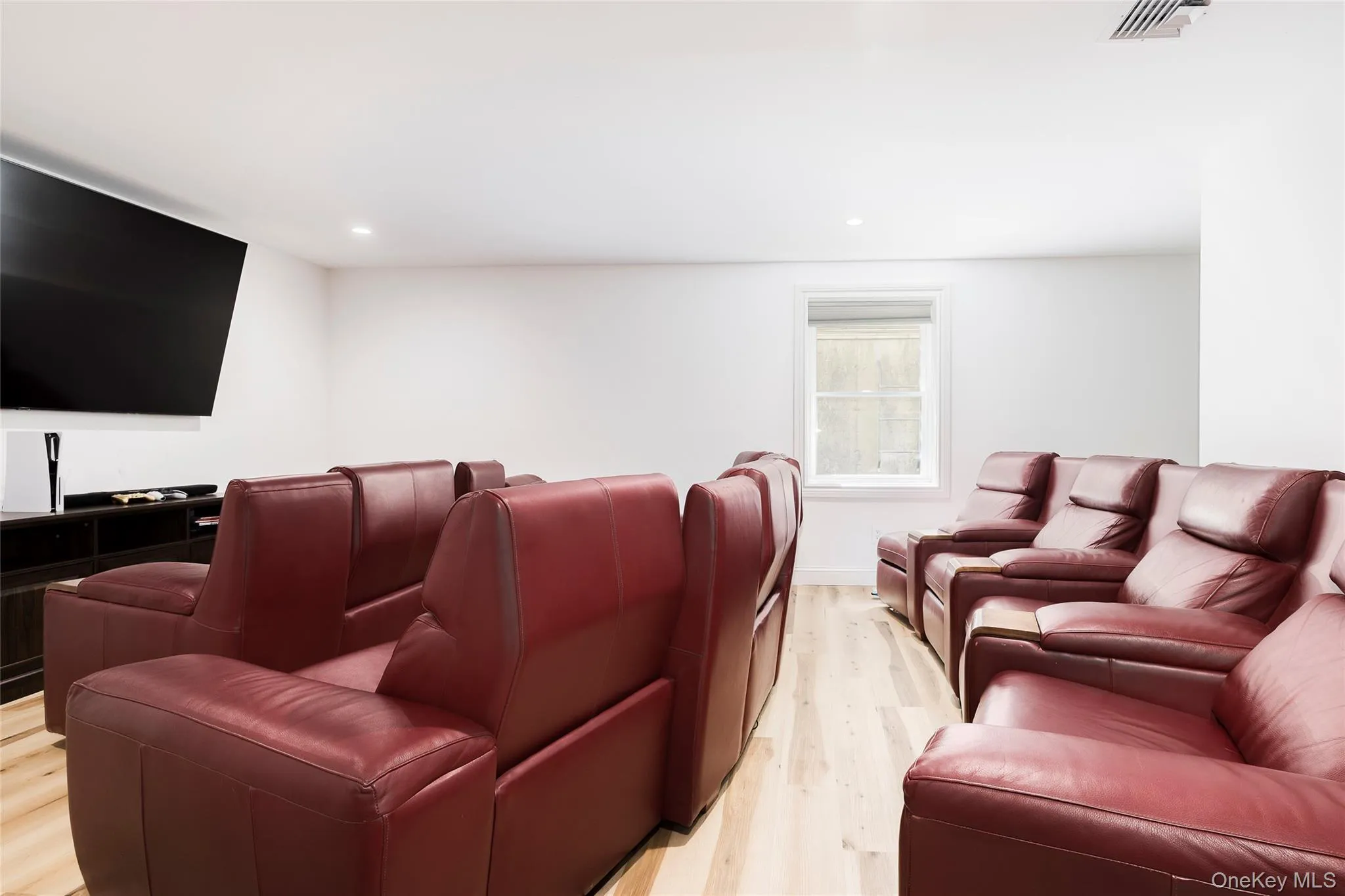 Cinema room with visible vents, recessed lighting, and light wood-style flooring Cinema room with visible vents, recessed lighting, and light wood-style flooring